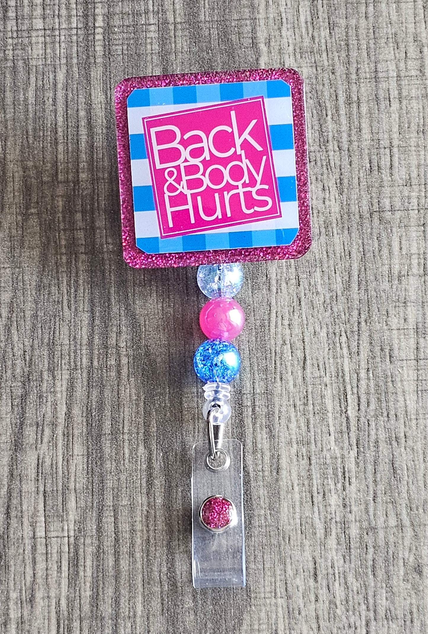 A badge reel that states back and body hurts