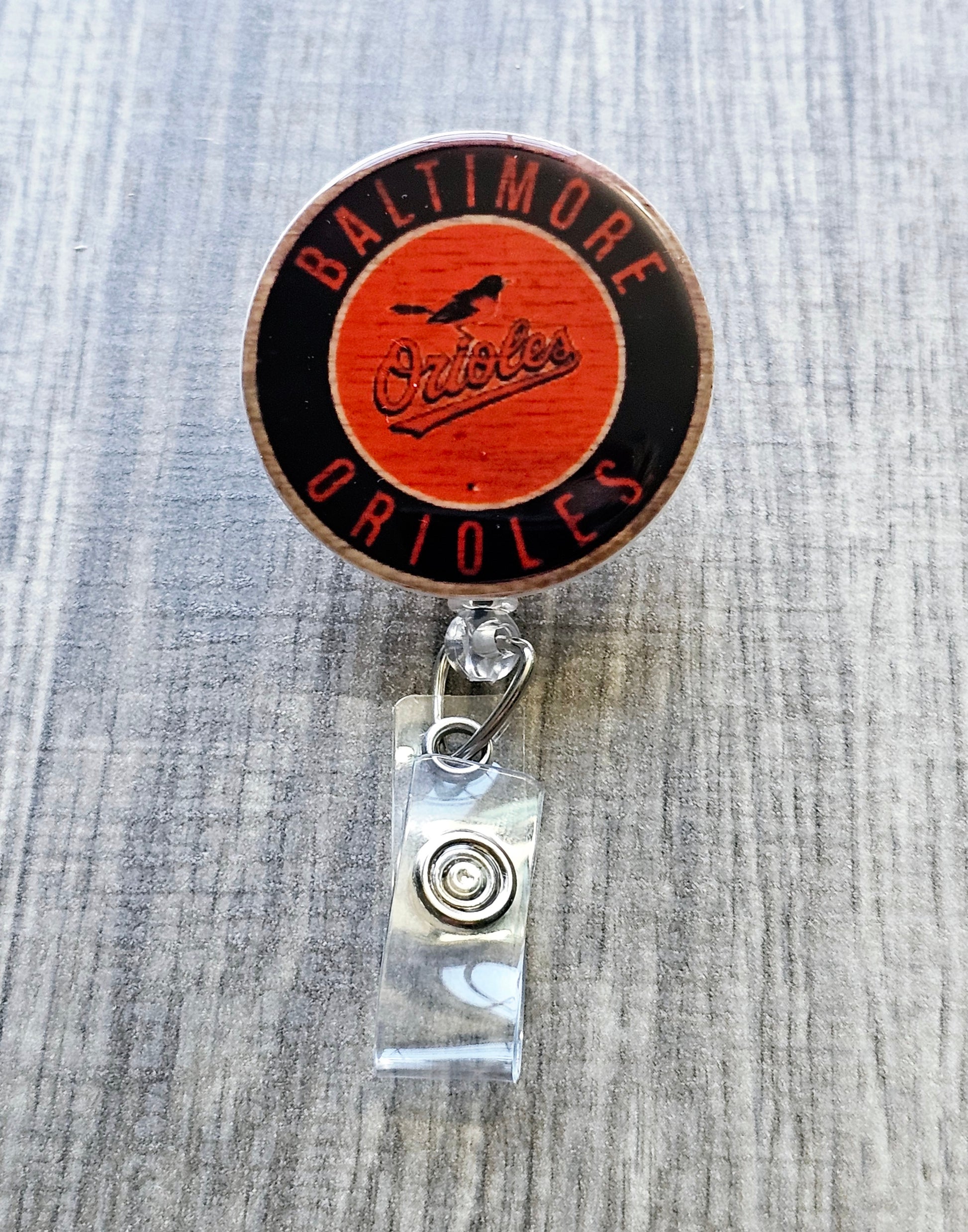 Baltimore Orioles-inspired badge reel with white acrylic.