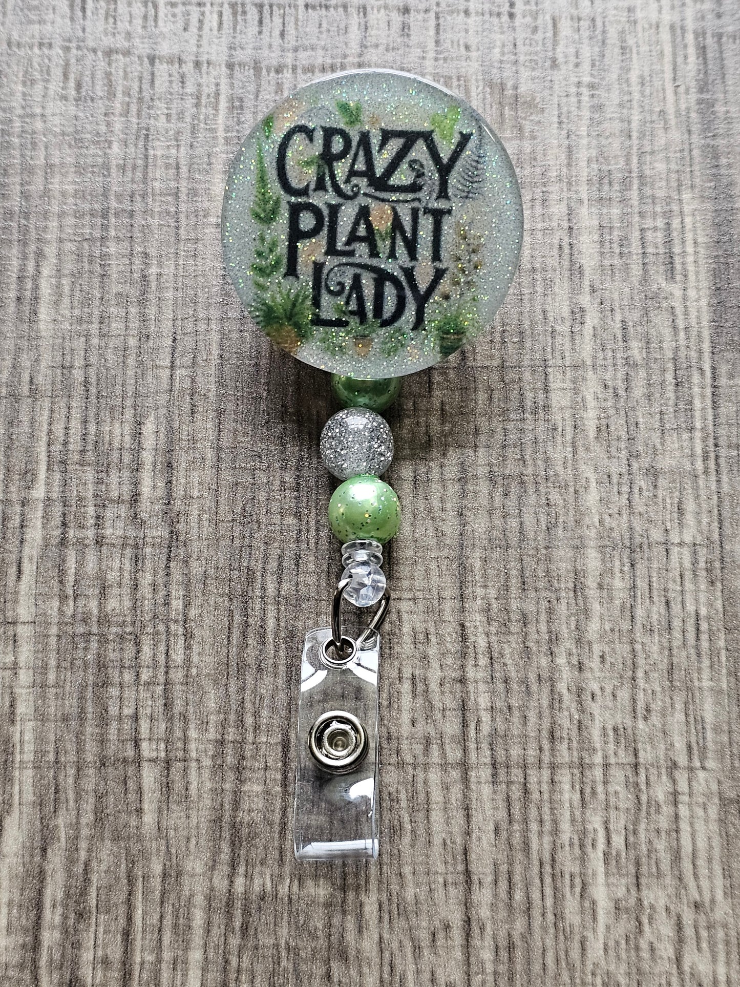 Green badge reel with Crazy Plant Lady quote and leaf accents