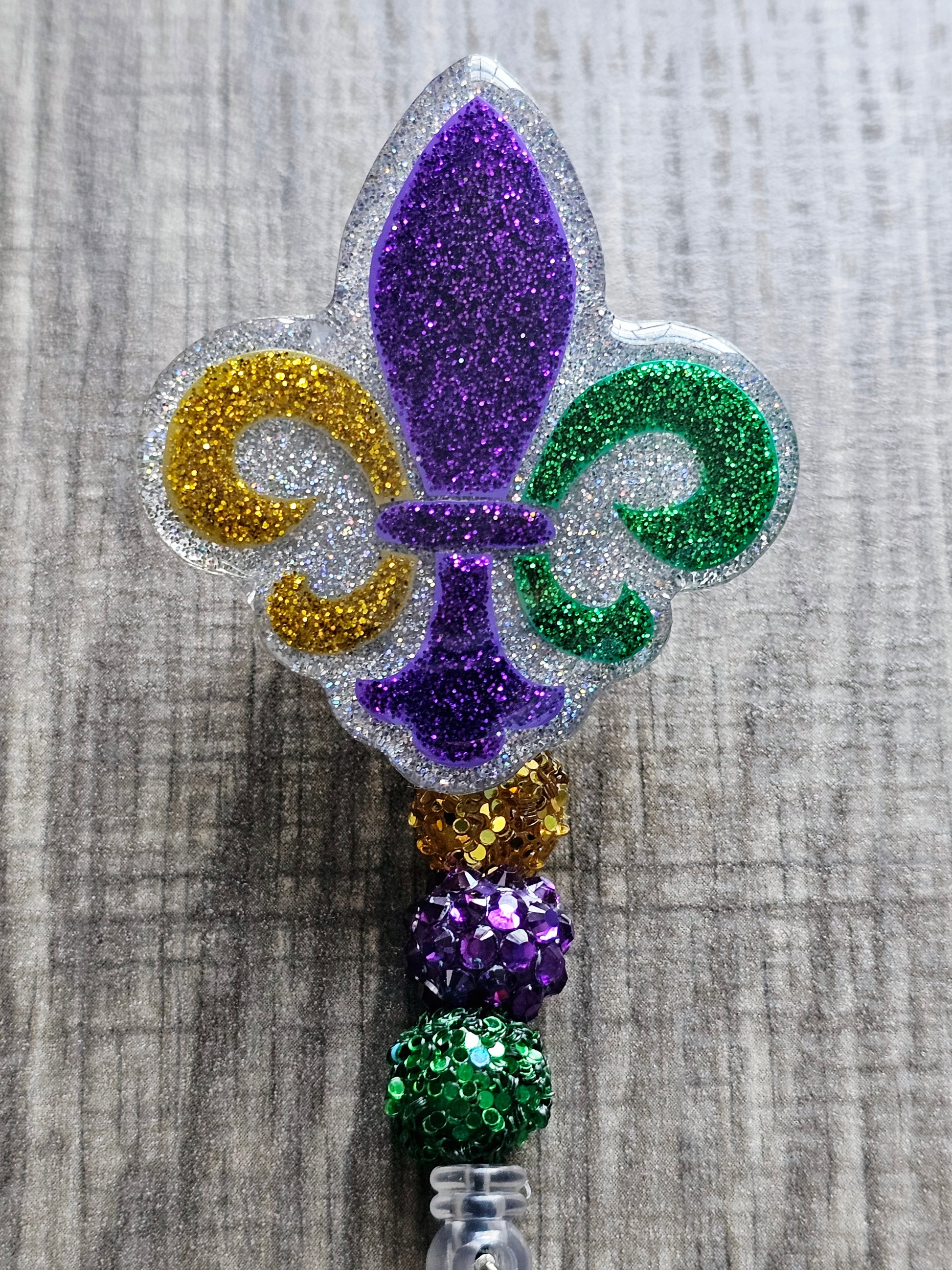 A badge reel featuring the Fleur de Lis Mardi Gras