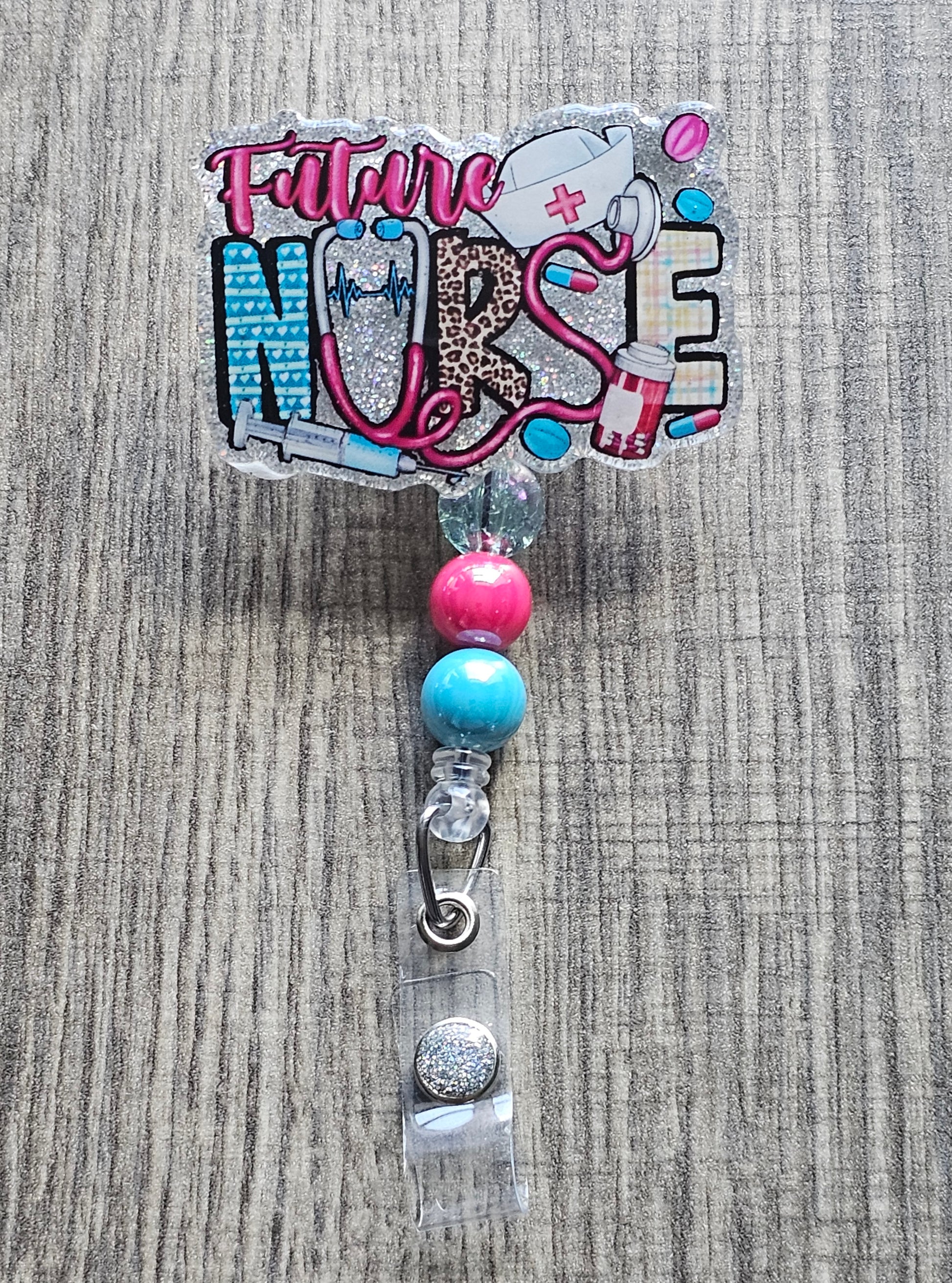 A badge reel featuring a bold design that incorporates essential medical symbols such as a stethoscope, syringe, pills, and a heartbeat.
