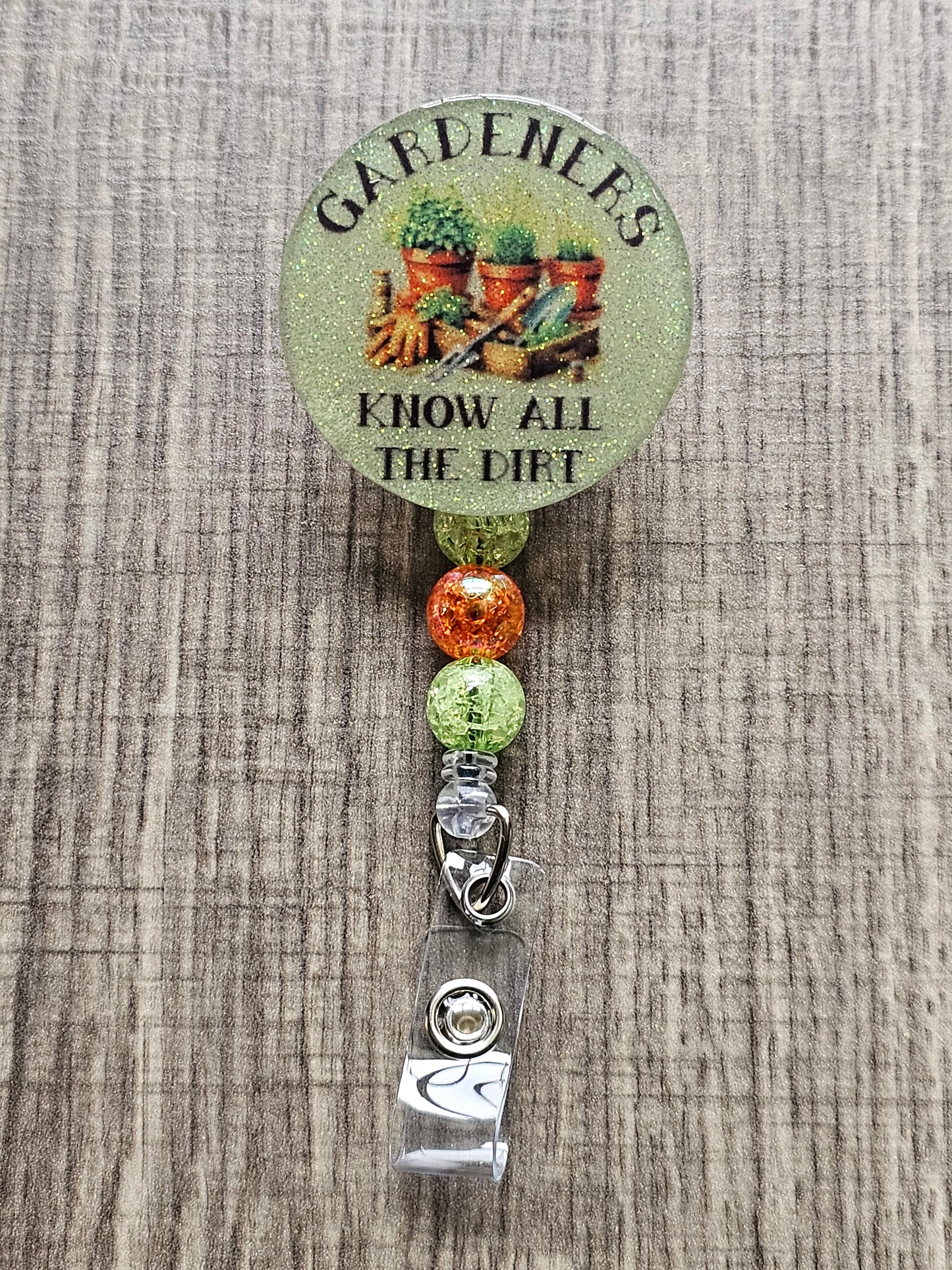Funny garden-themed badge reel reading Gardeners Know All the Dirt