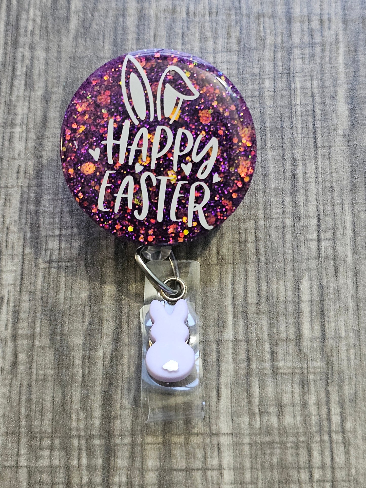 A Badge Reel with a purple background and the words Happy Easter