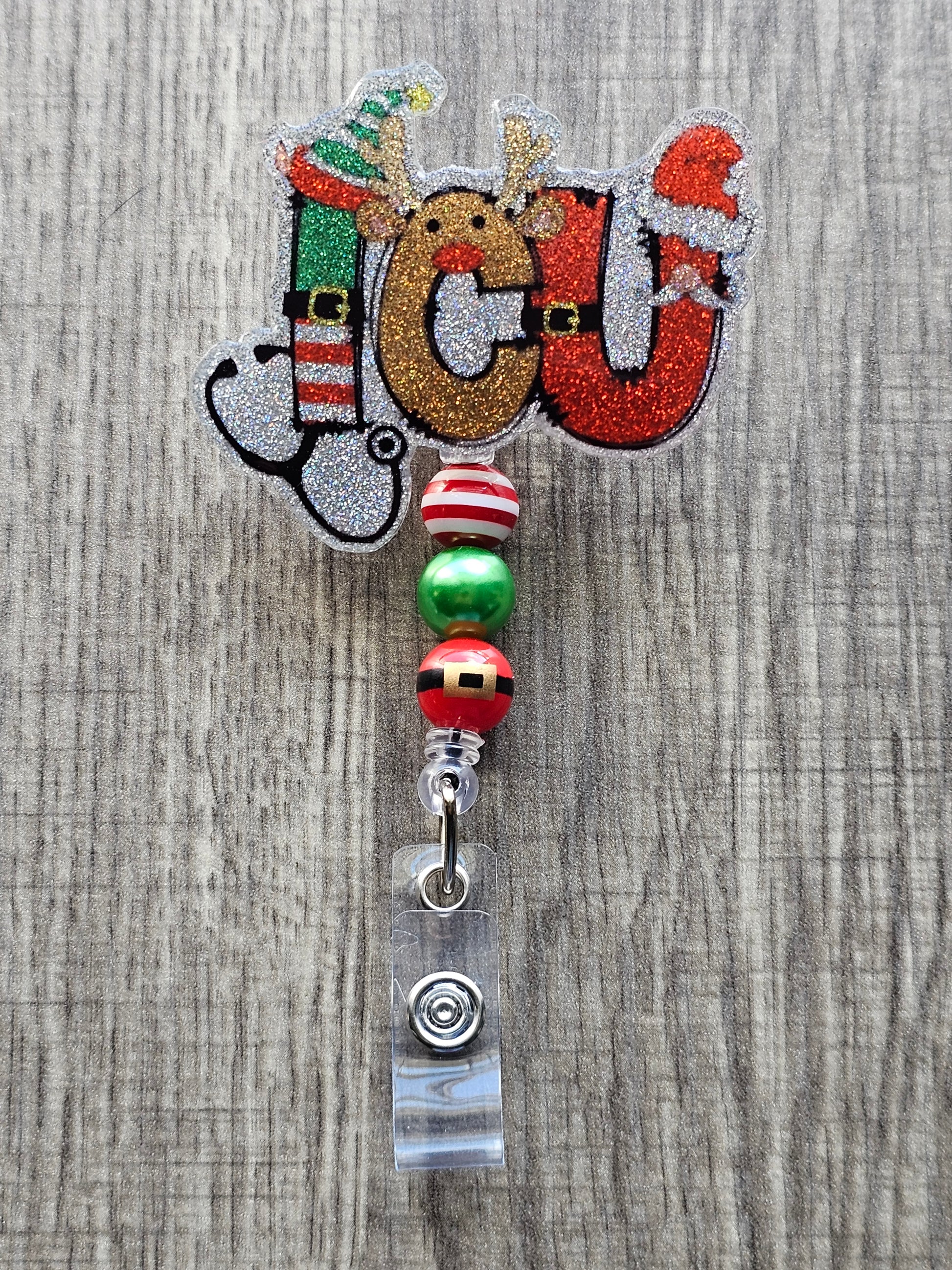 A badge reel stating ICU while the letters are decorated in a festive manner paired with a stethoscope.