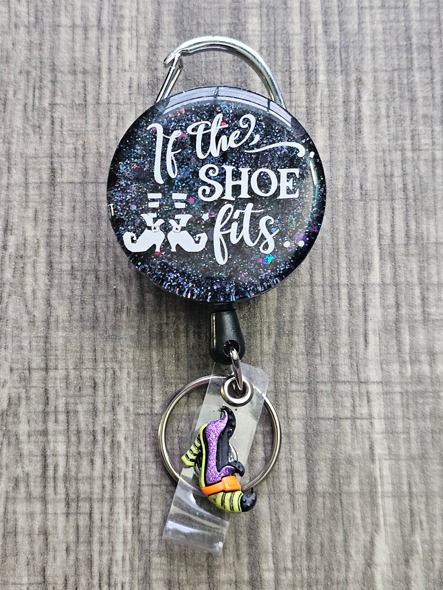 A Halloween Badge Reel with a starry background and the words If The Shoe Fits