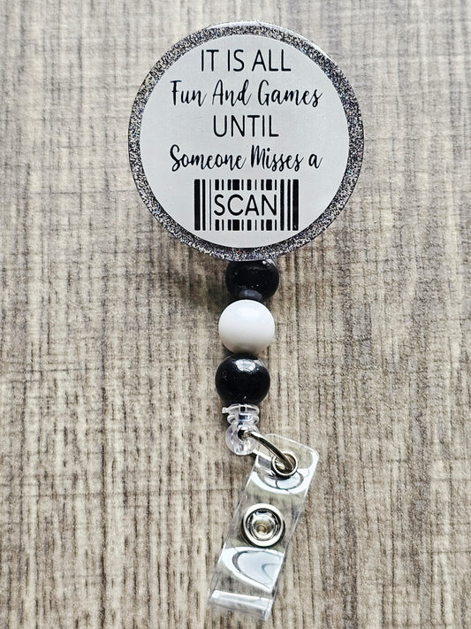Funny badge reel with barcode graphic and the phrase “It’s all fun and games until someone misses a scan.”