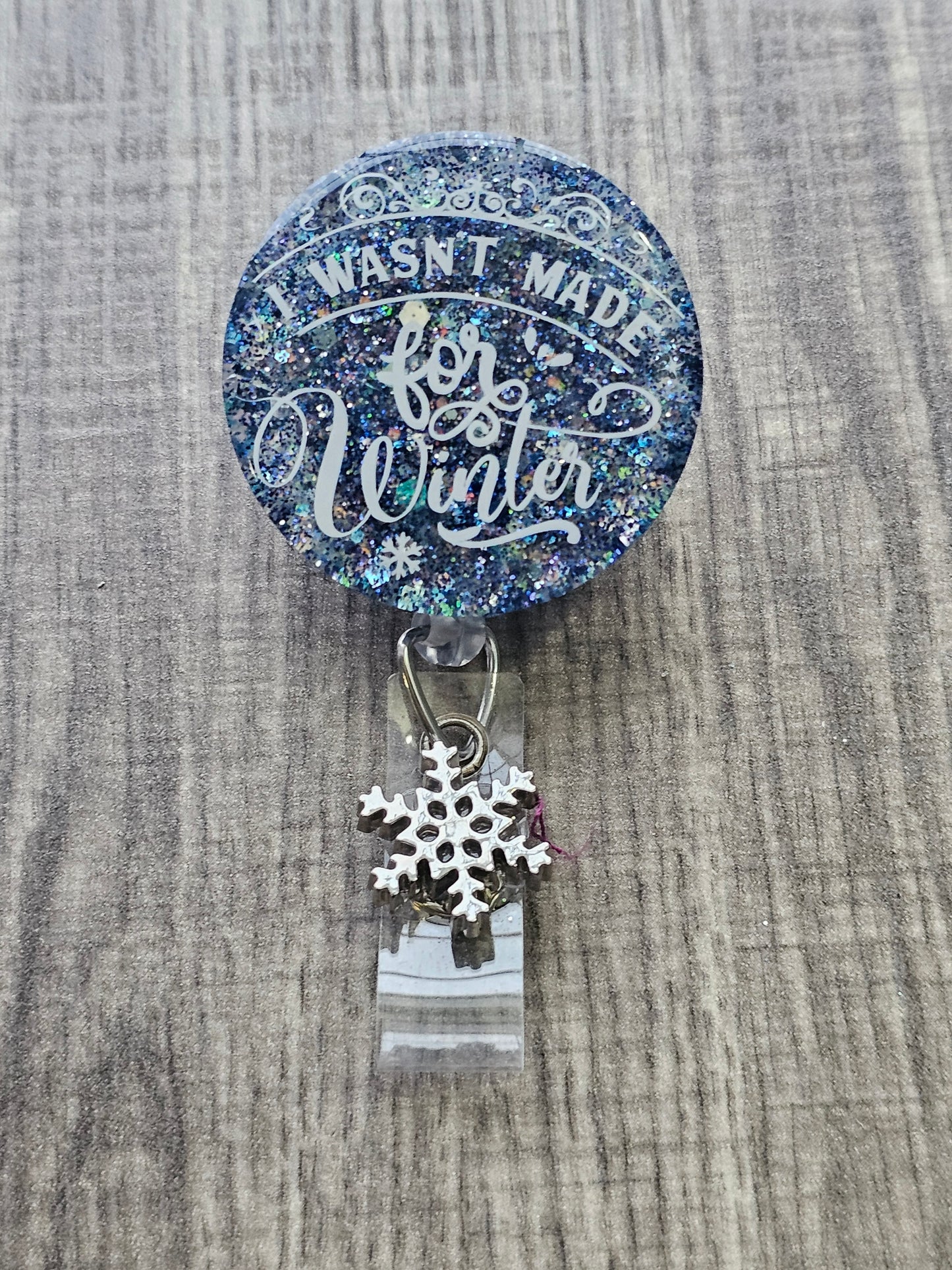 A badge Reel Stating I wasn't made for the winter.