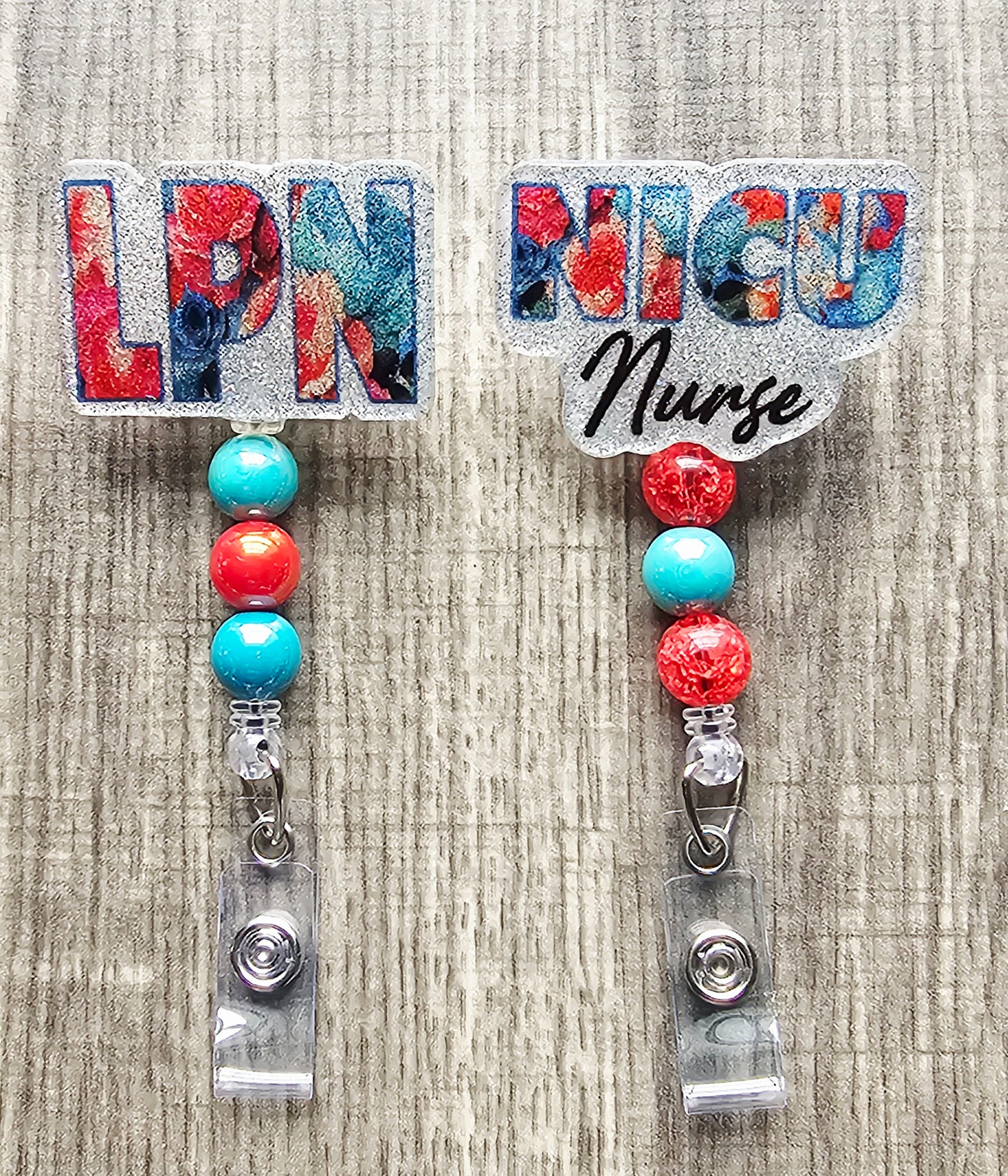 Pink and teal flower badge reel with OR Nurse title and color-coordinated clip.