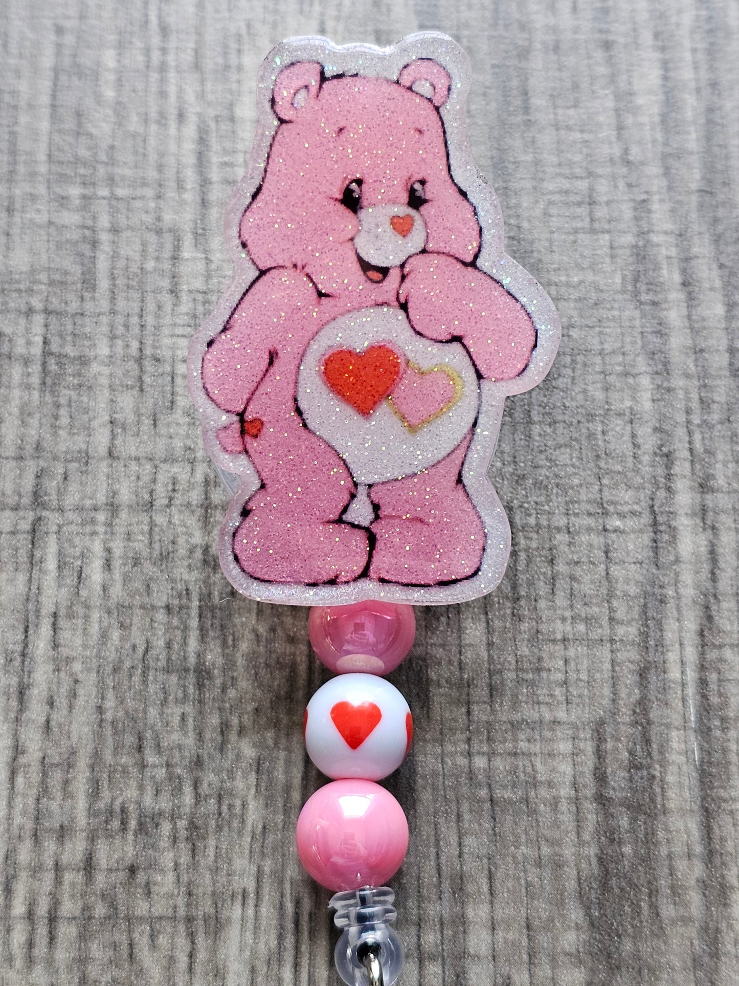 A cute badge reel featuring the love-a-lot bear with two hearts on its stomach for valentine's day.