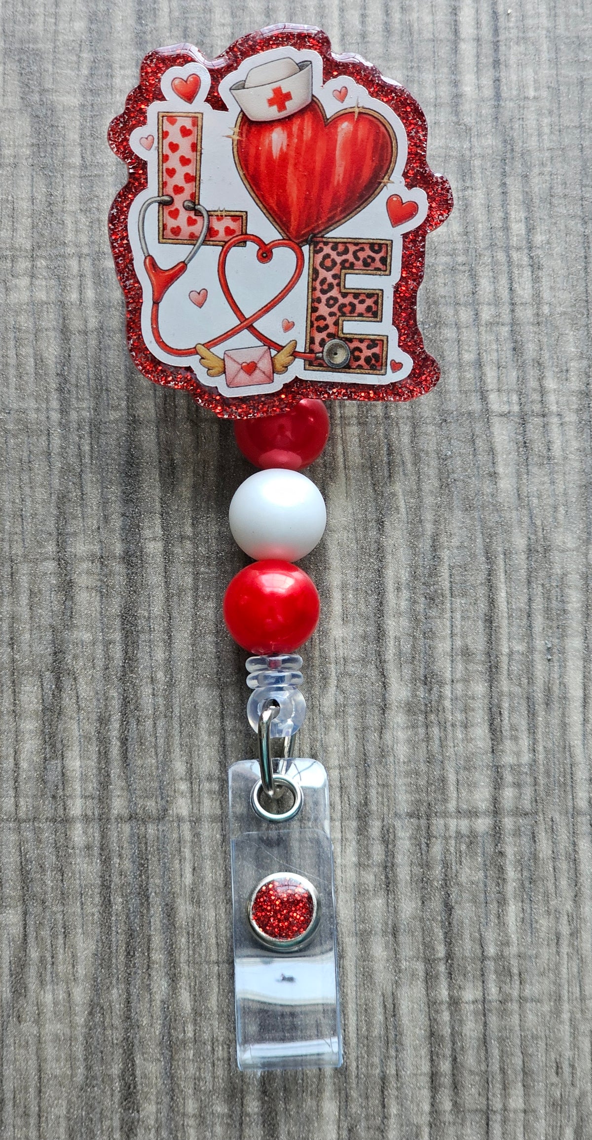 Decorative badge holder with a red heart, nurse hat, and 'LOVE' creatively decorated for Valentine's day text on a textured background.