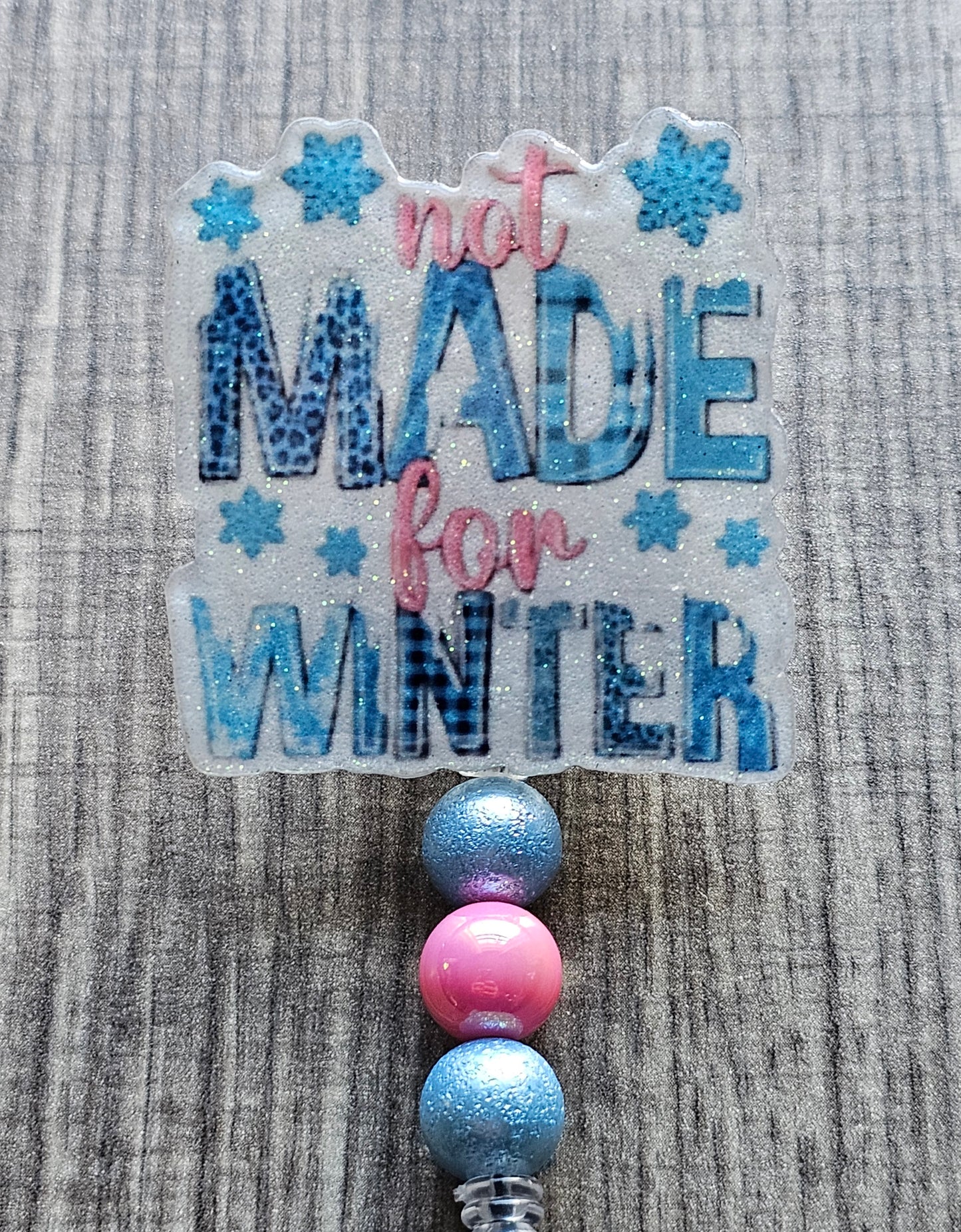 A badge reel stating not made for winter