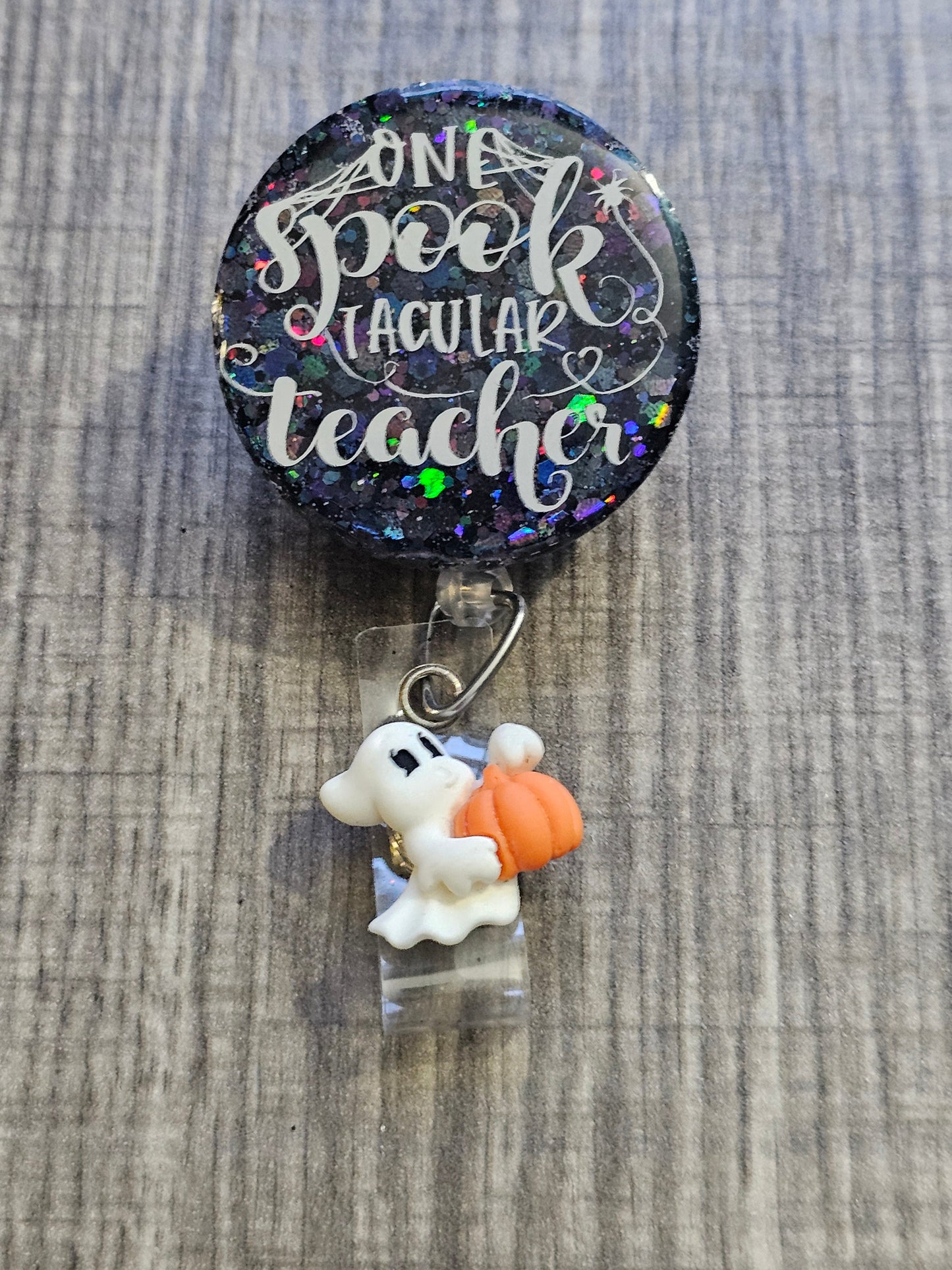 A Badge Reel with the statement One Spooktacular Teacher with a halloween theme.