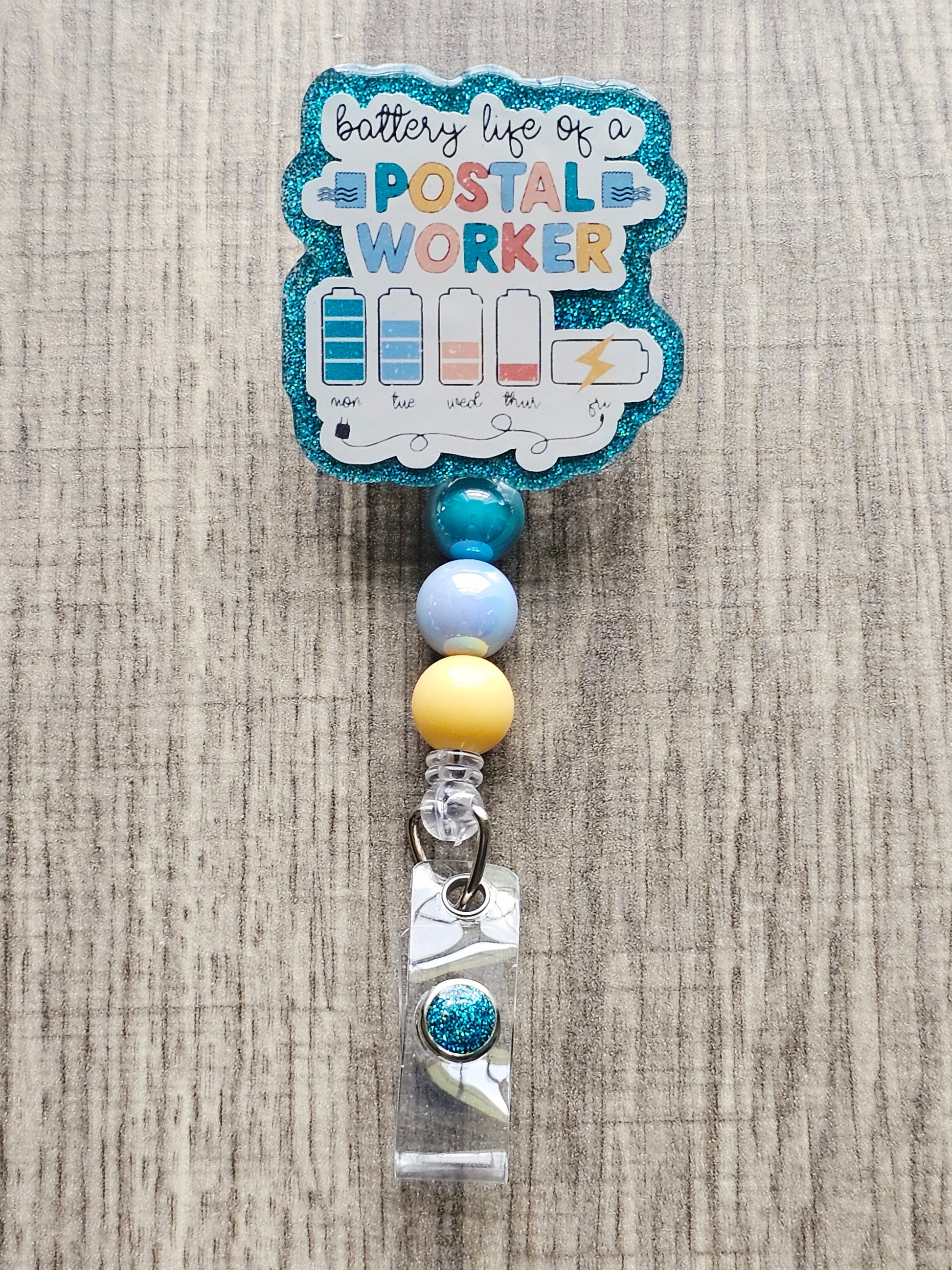 Badge reel showing the battery life of a postal worker draining throughout the week.