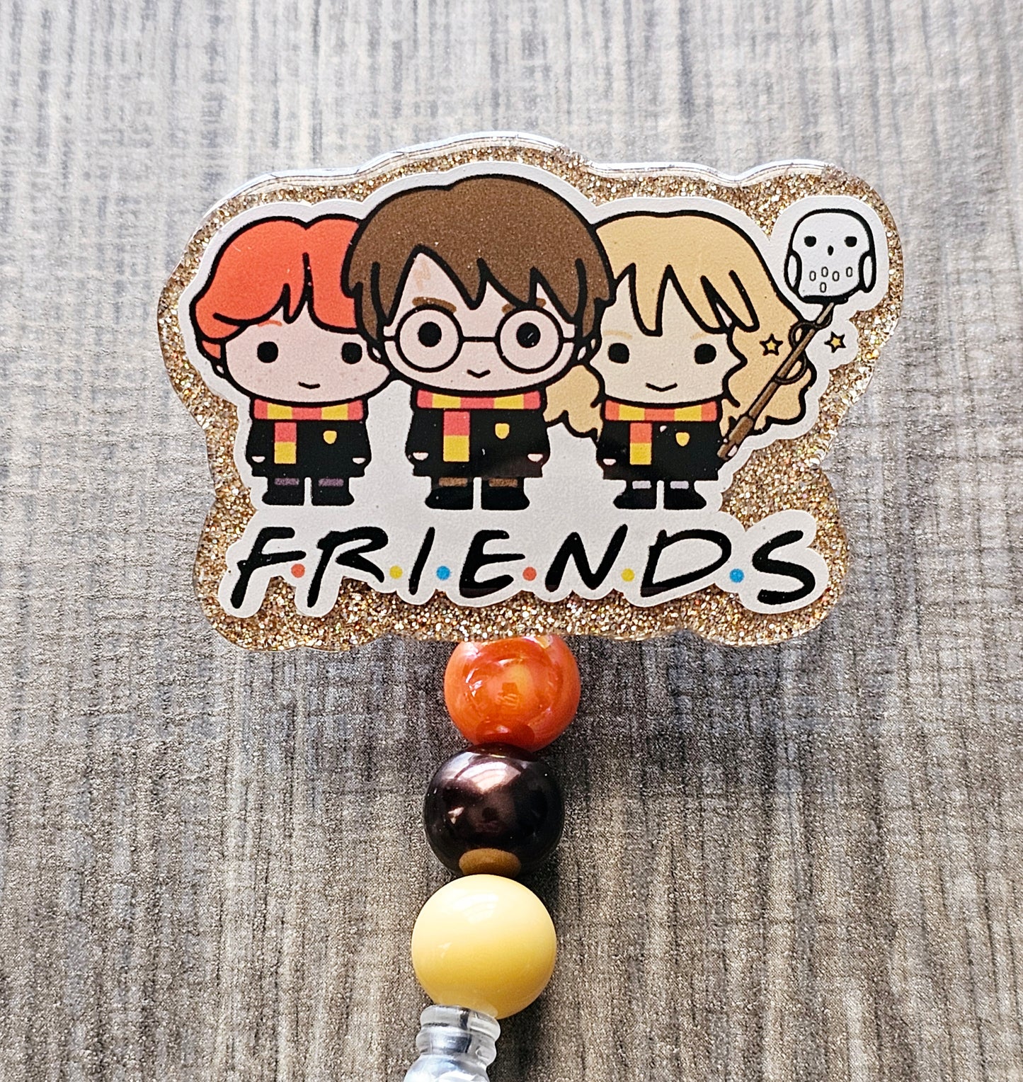 A badge reel featuring a wizard trio design with the well-known Friends TV show font.