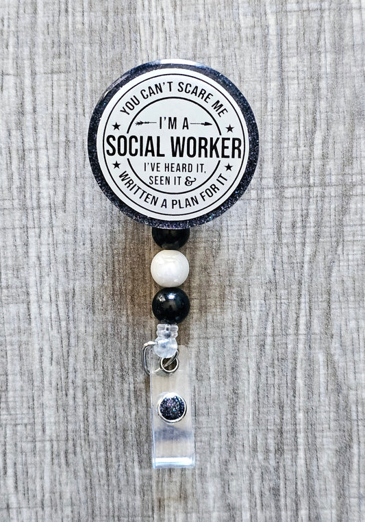 Social worker badge reel with the phrase "You Can’t Scare Me, I’m a Social Worker – I’ve Heard It, Seen It & Written a Plan for It" on a glittery background.