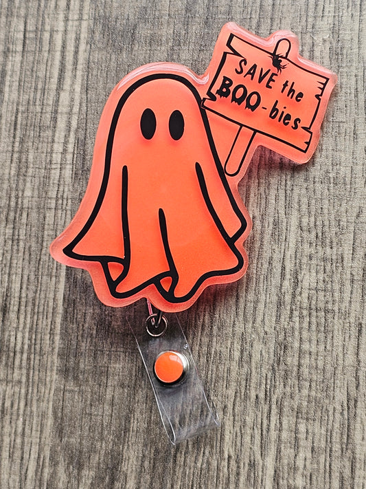 an orange ghost holding a sign stating save the boo-bies with a goal of bringing awareness to breast cancer month