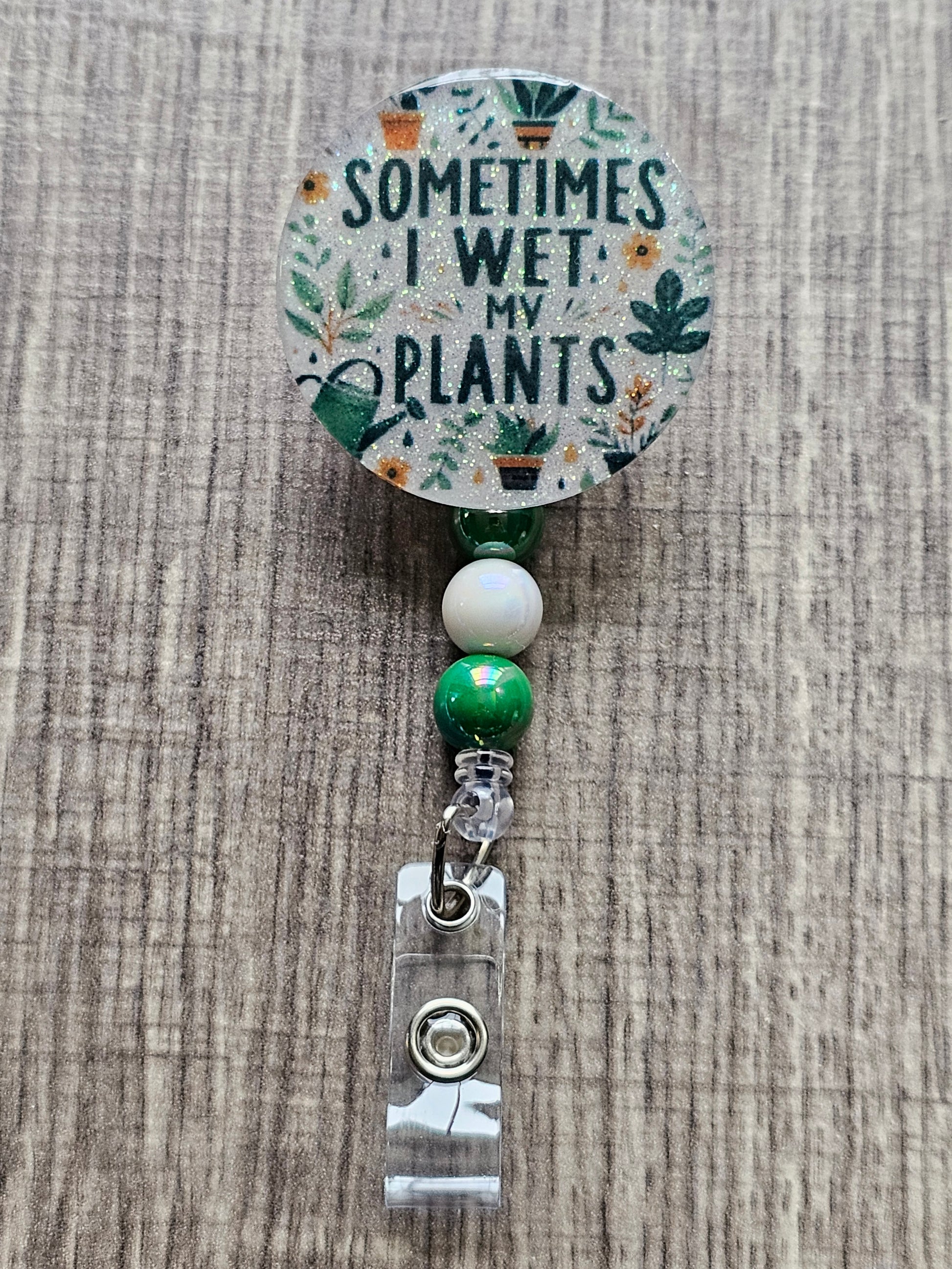 Humorous ID badge reel with the quote Sometimes I Wet My Plants in a green theme