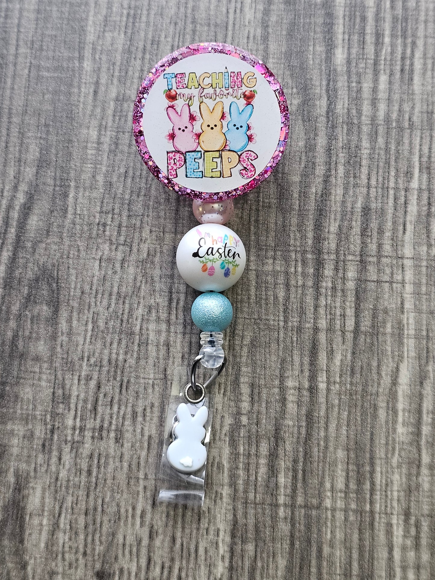 A badge reel stating teaching my favorite peeps with 3 adorable bunnies displayed at the front of the badge reel.