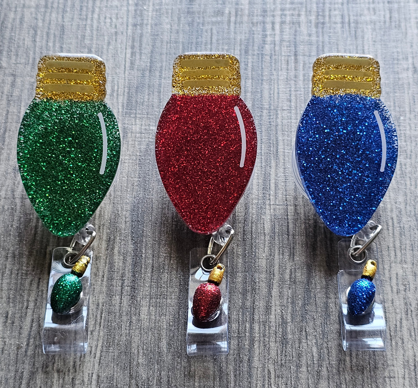 Badge reels that are shaped like Christmas lights and is available in different colors such as red, green, and blue