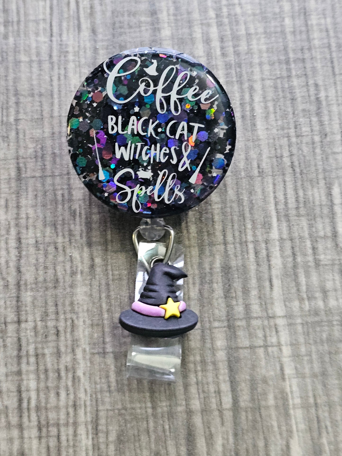 A Halloween Badge Reel with the statement coffee, black cat, witches & Spells