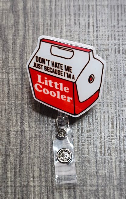 Retractable badge reel shaped like a blue cooler with the pun "Don't hate me because I'm a little Cooler.