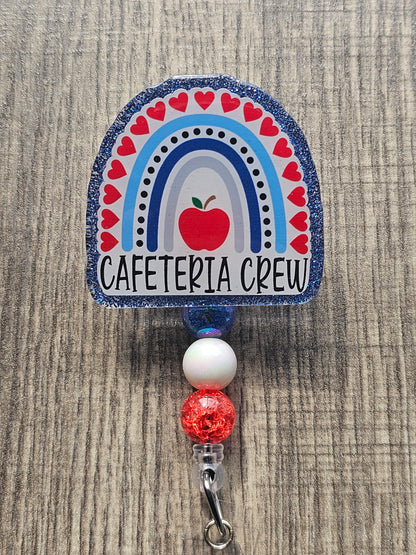 Features an apple surrounded by a rainbow full of hearts while stating cafeteria crew at the bottom