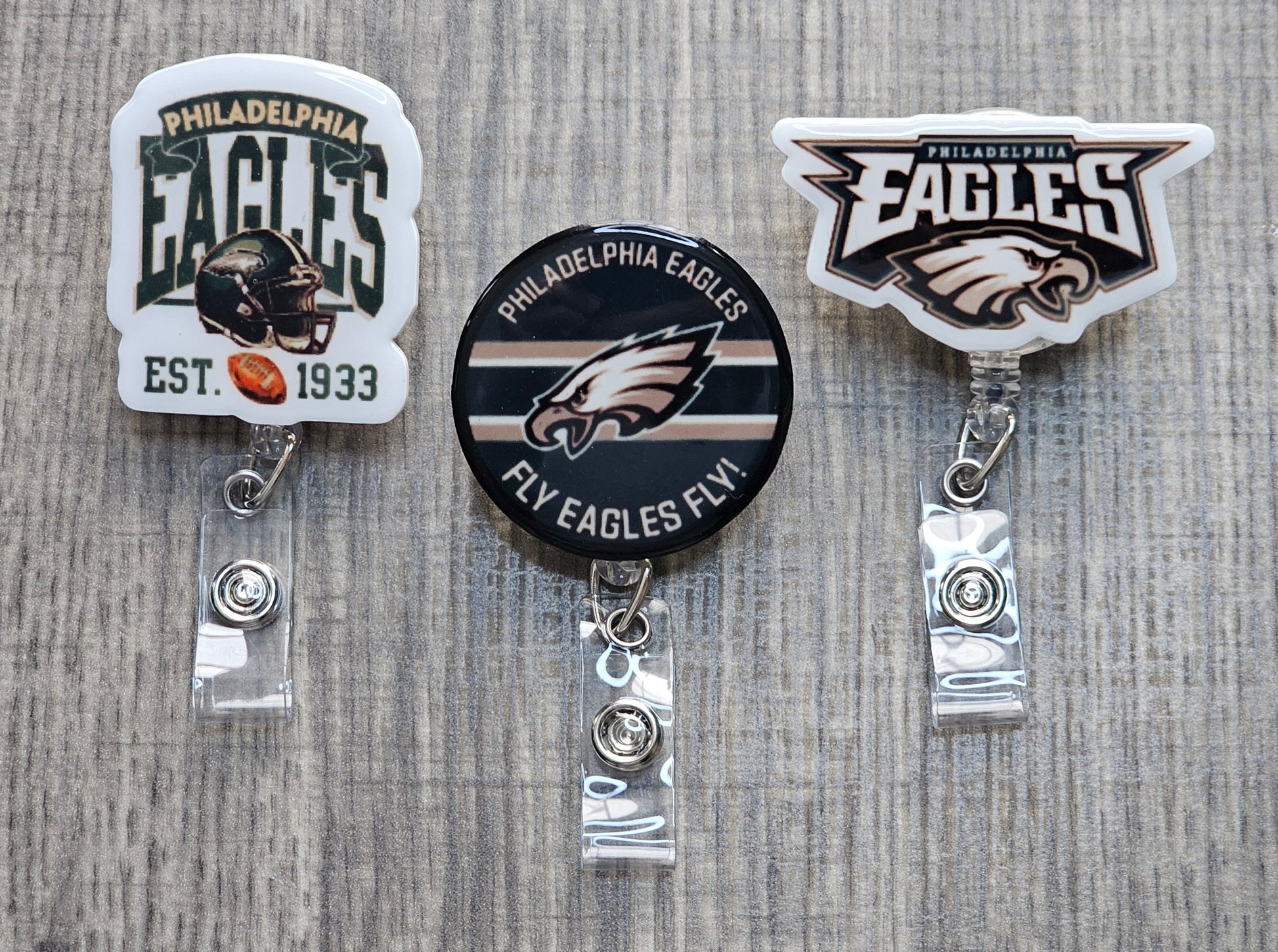 Collection of Philadelphia Eagles badge reels including Fly Eagle Fly, 1933 Vintage, and Bold Mascot designs.