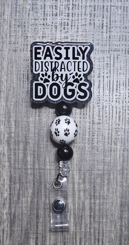 Badge holder with 'Easily Distracted by Dogs' text on a gray textured background