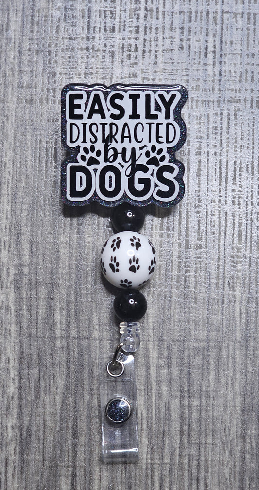Badge holder with 'Easily Distracted by Dogs' text on a gray textured background