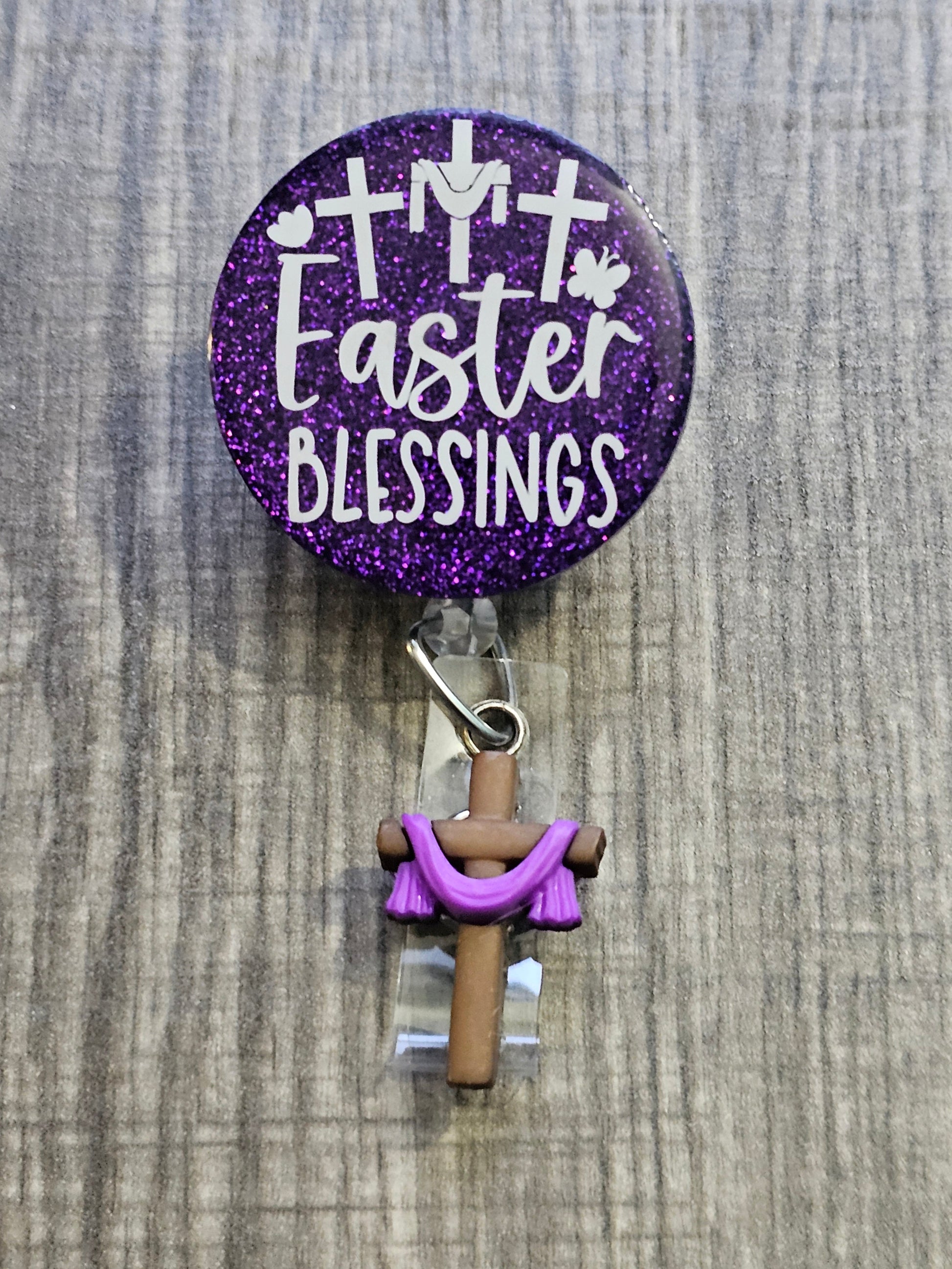  A Badge Reel purple in color with 3 crosses to represent the crucifying of Christ