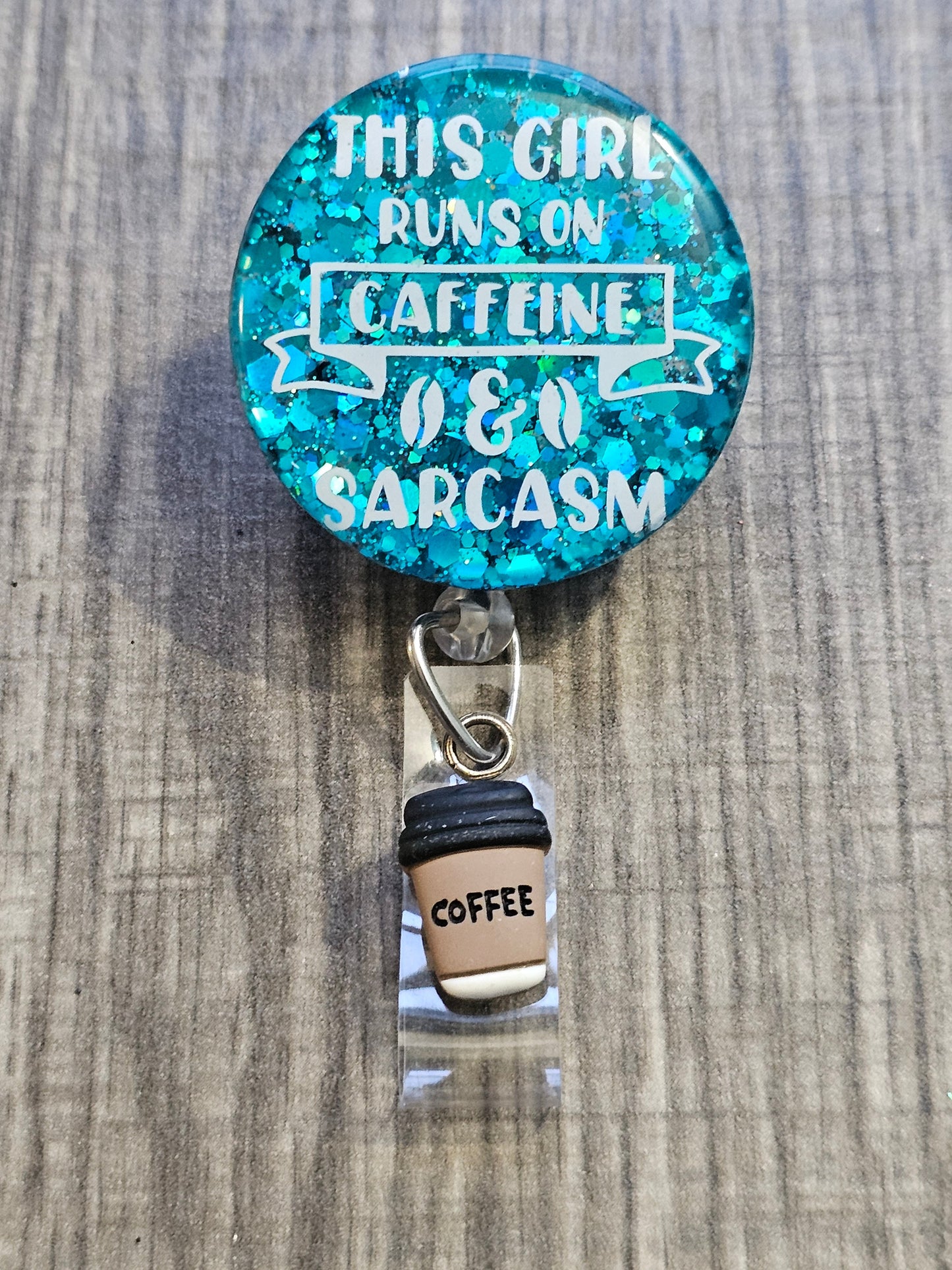  A Badge Reel with the statement This Girls Runs of Caffeine & Sarcasm