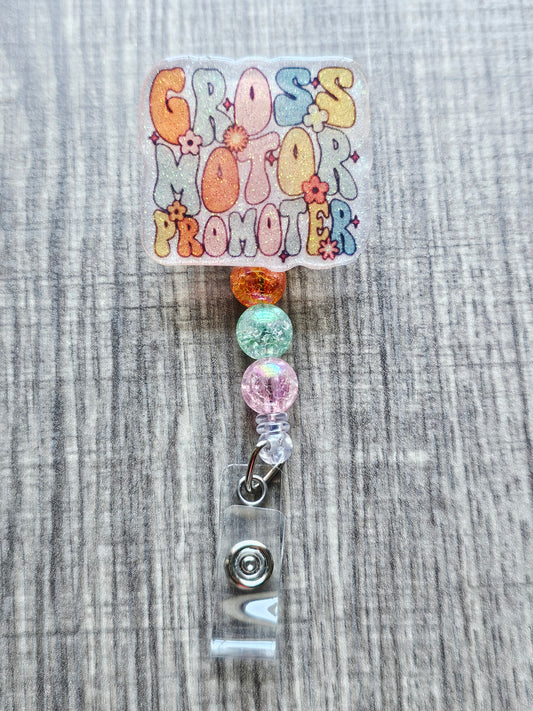 Retro floral badge reel with the words "Gross Motor Promoter" for physical therapists.