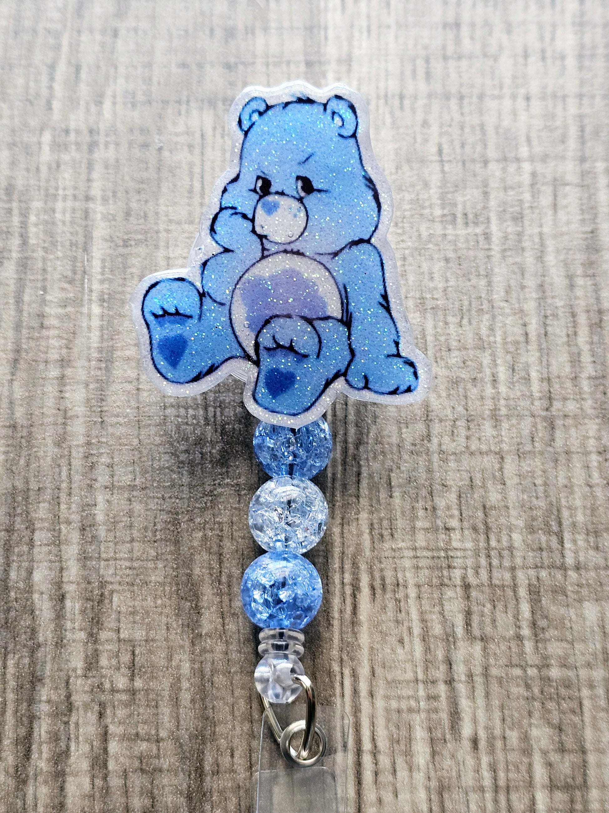 A badge reel featuring a grumpy blue bear with a nostalgic, fun design.