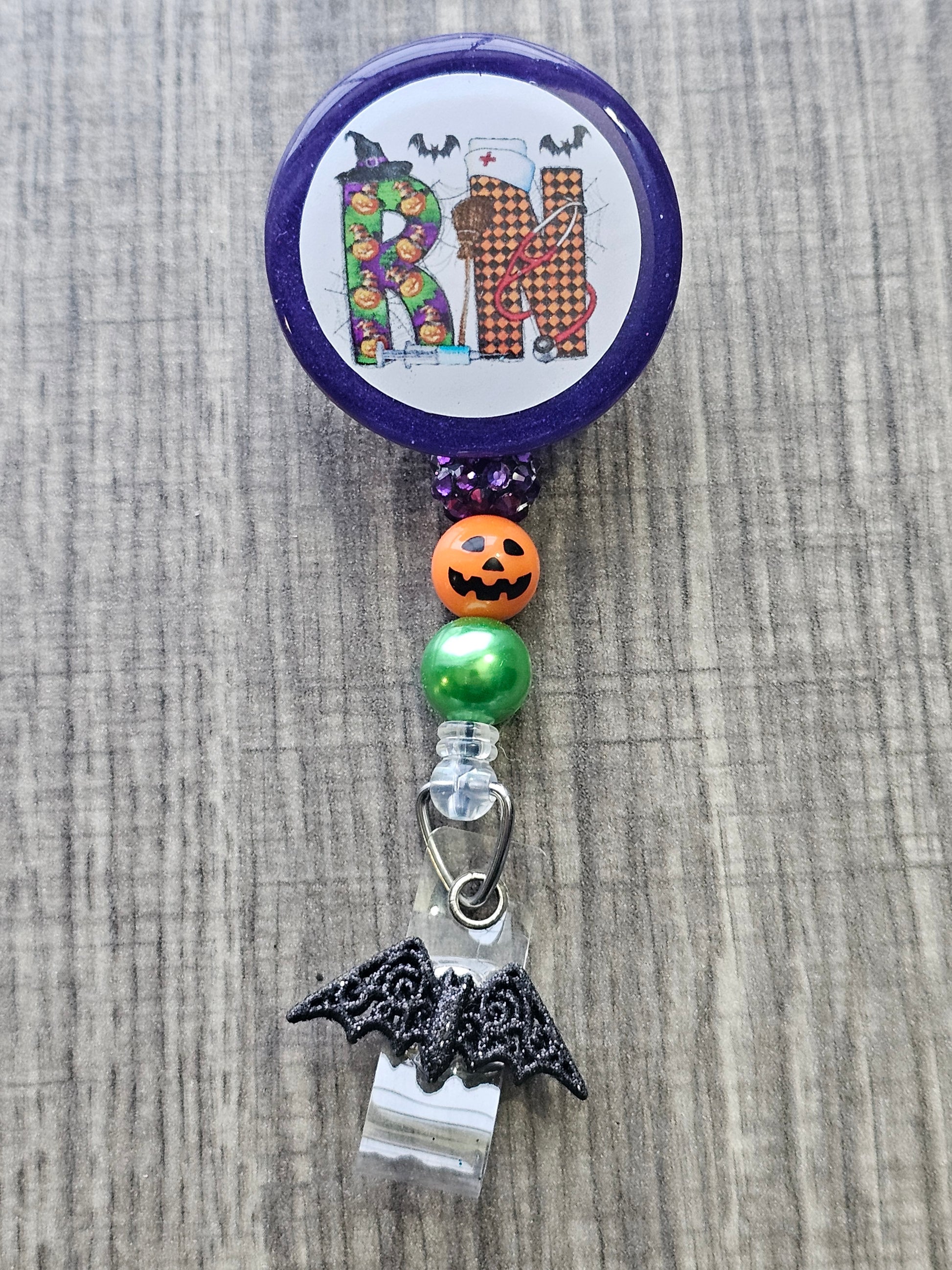 A Halloween themed badge with the letters RN in support of registered Nurses.