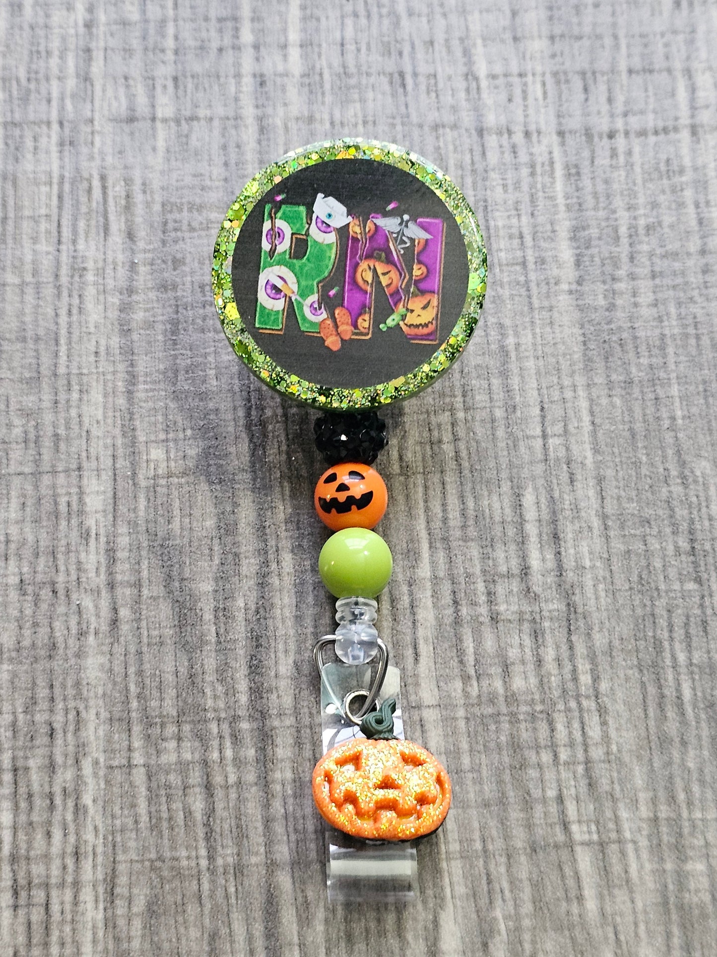  A Halloween themed Badge Reel with the letters RN for Registered Nurse