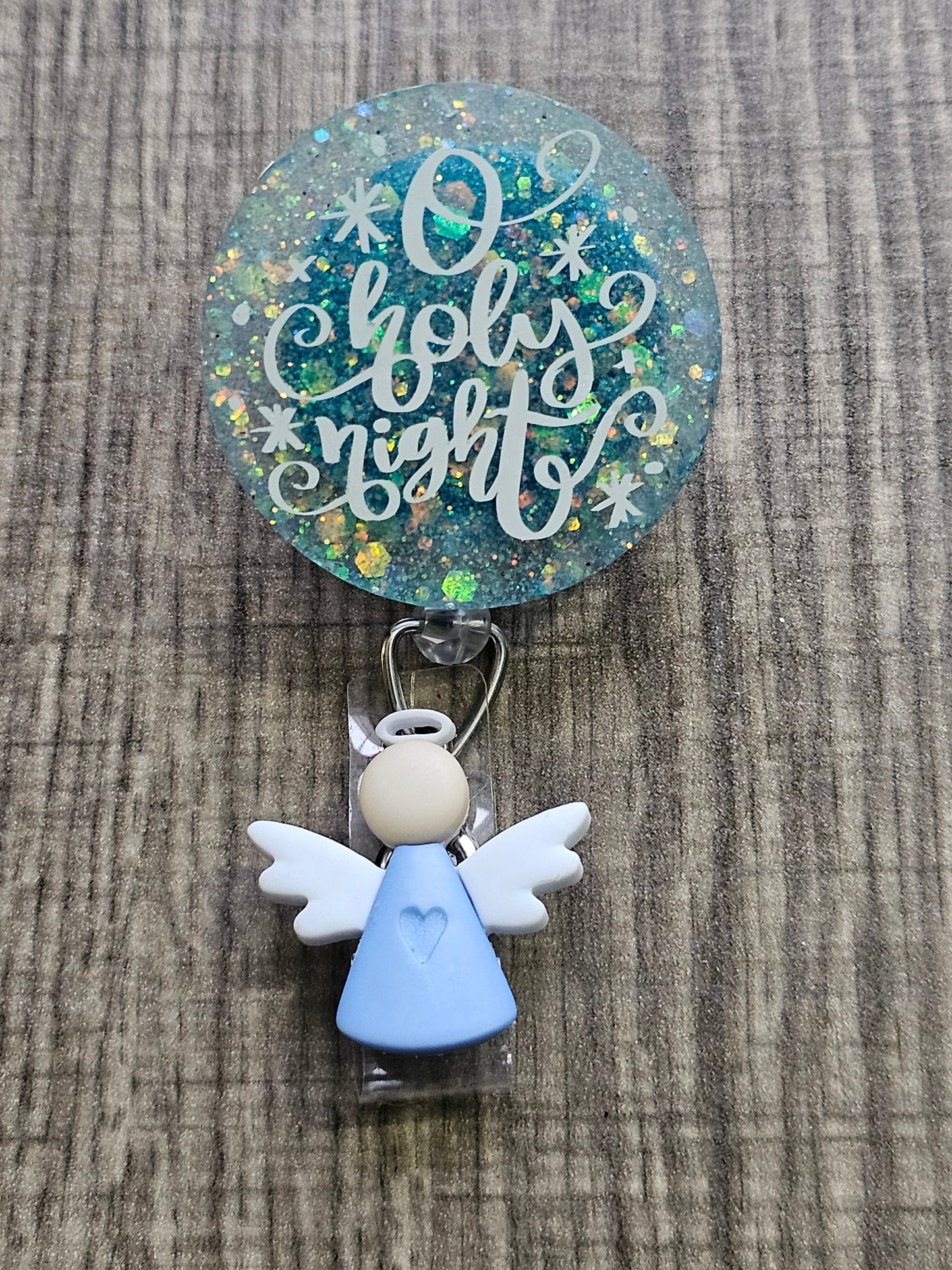  A Badge Reel featuring the statement Holy night with a festive background and an angel clip