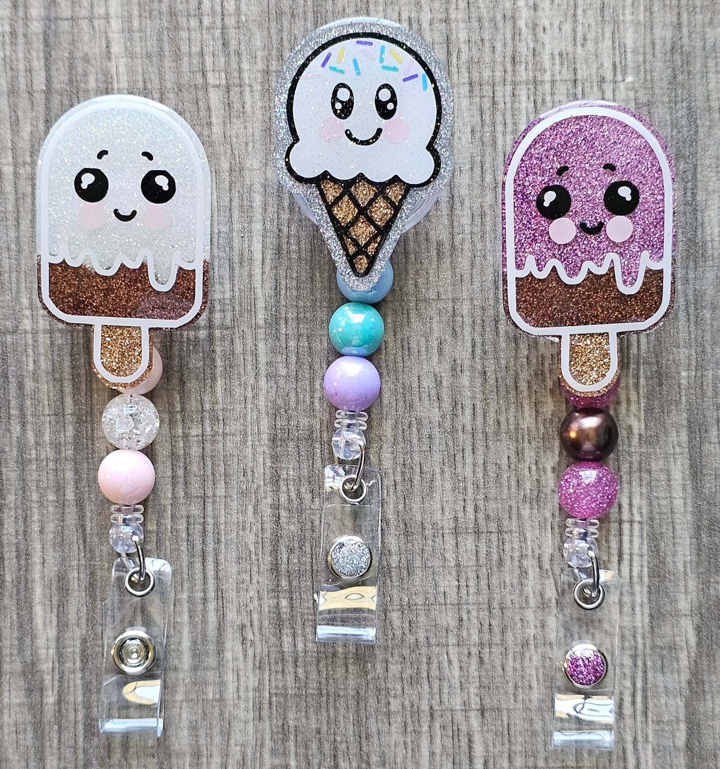 Collection of summer treat badge reels, including a vanilla chocolate popsicle , chocolate strawberry, and a vanilla ice cream cone with sprinkles.