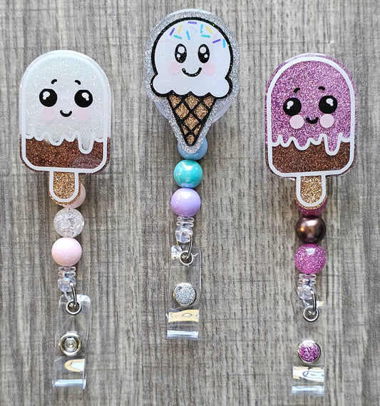Collection of summer treat badge reels, including a vanilla chocolate popsicle , chocolate strawberry, and a vanilla ice cream cone with sprinkles.