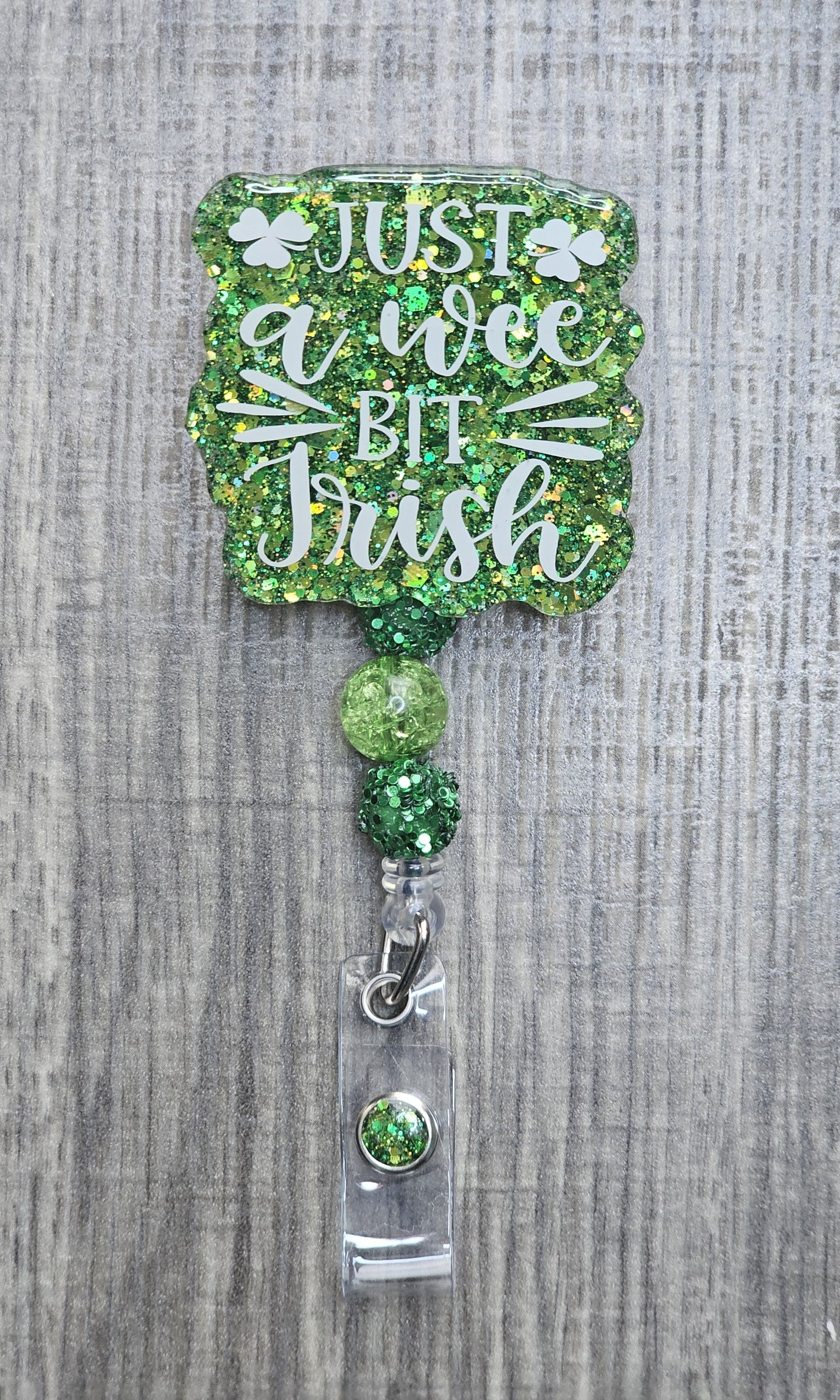 Beaded badge reel for St. Patrick's Day with "Just a Wee Bit Irish" text and matching green and white decorative beads.