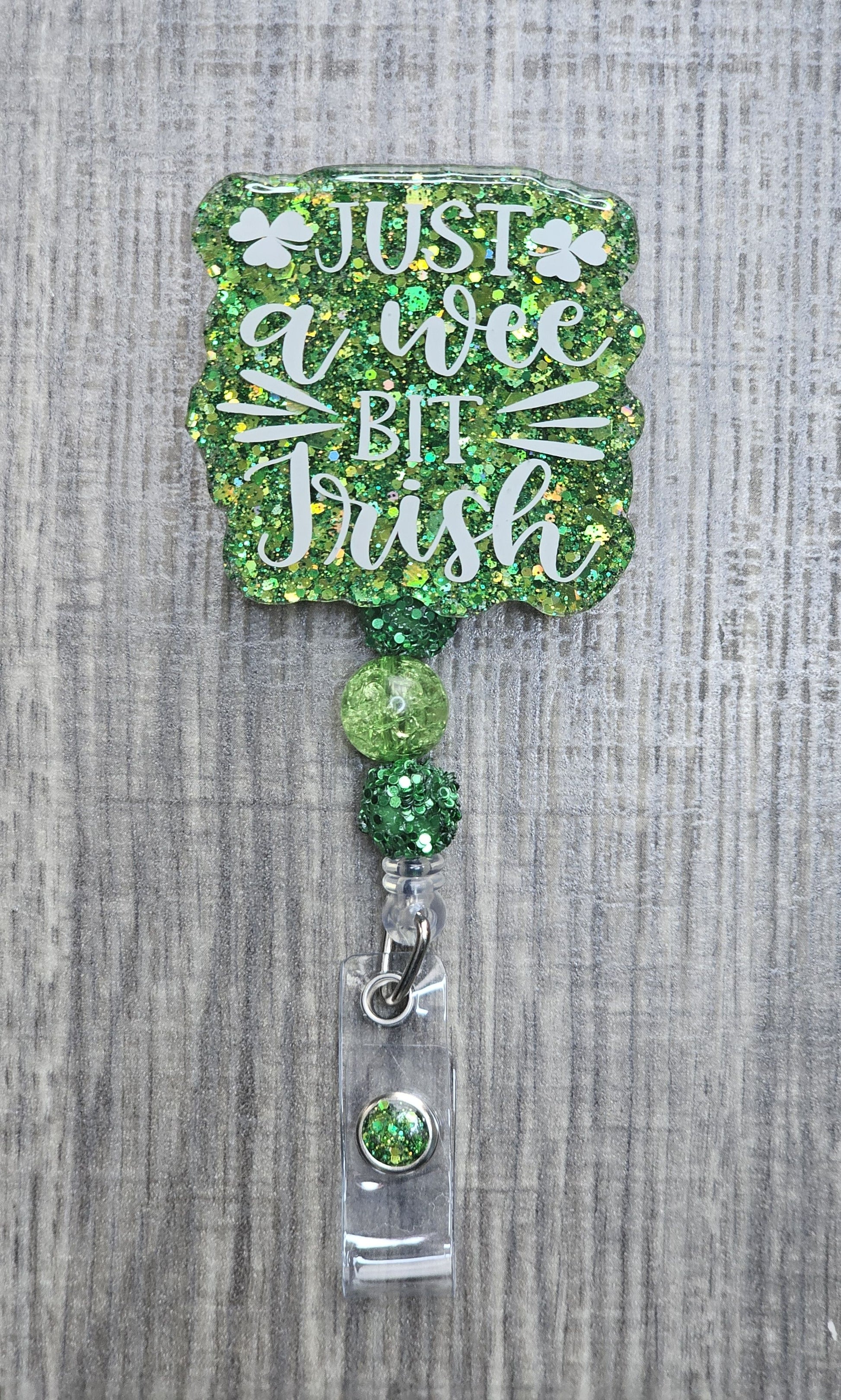 Beaded badge reel for St. Patrick's Day with "Just a Wee Bit Irish" text and matching green and white decorative beads.