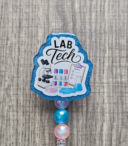 Lab tech badge reel featuring a microscope, vials, platelet sampler, checklist, and medical glove icons with matching beads.