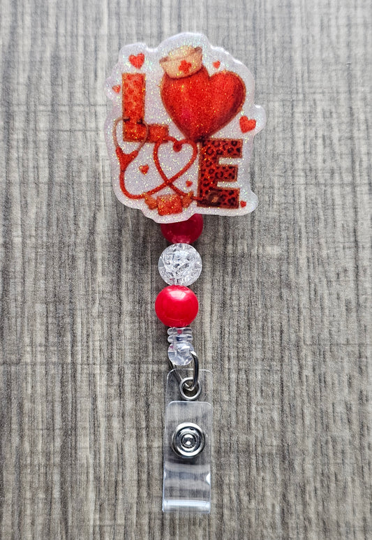Valentine themed LOVE badge reel with nurse hat and stethoscope letters in red and white.