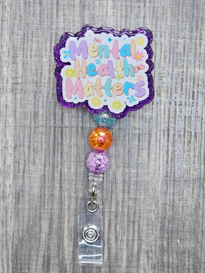 Mental Health Matters badge reel with flowers, butterflies, and smiles with beads.