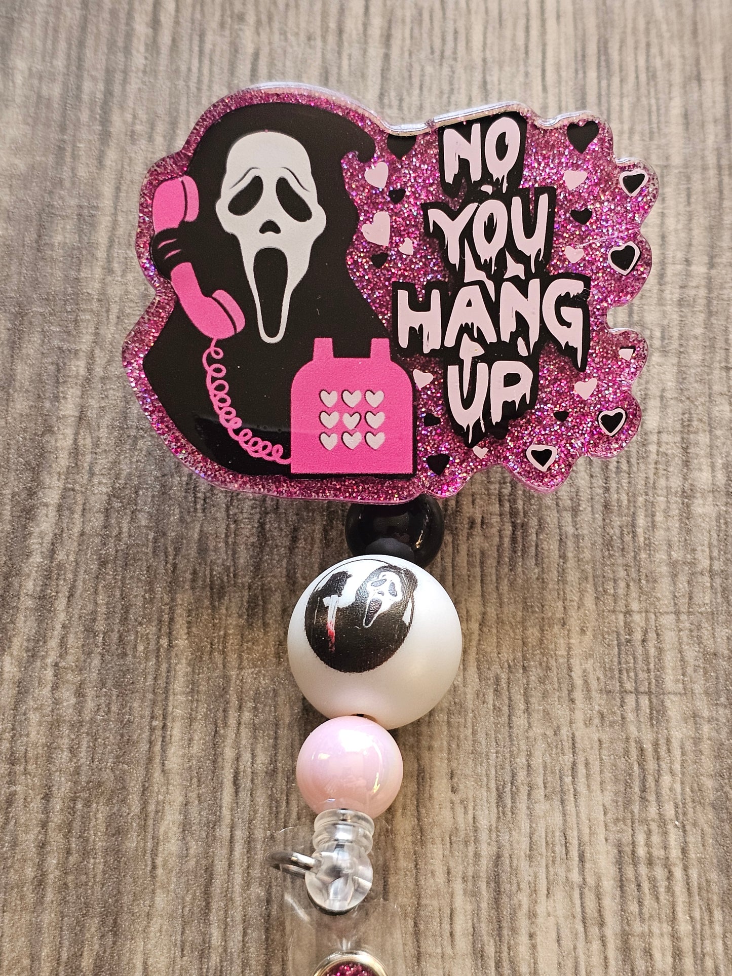 A badge Reel featuring ghost face from the movie scream holding up a phone to his ear with the words No You Hang up next to him 