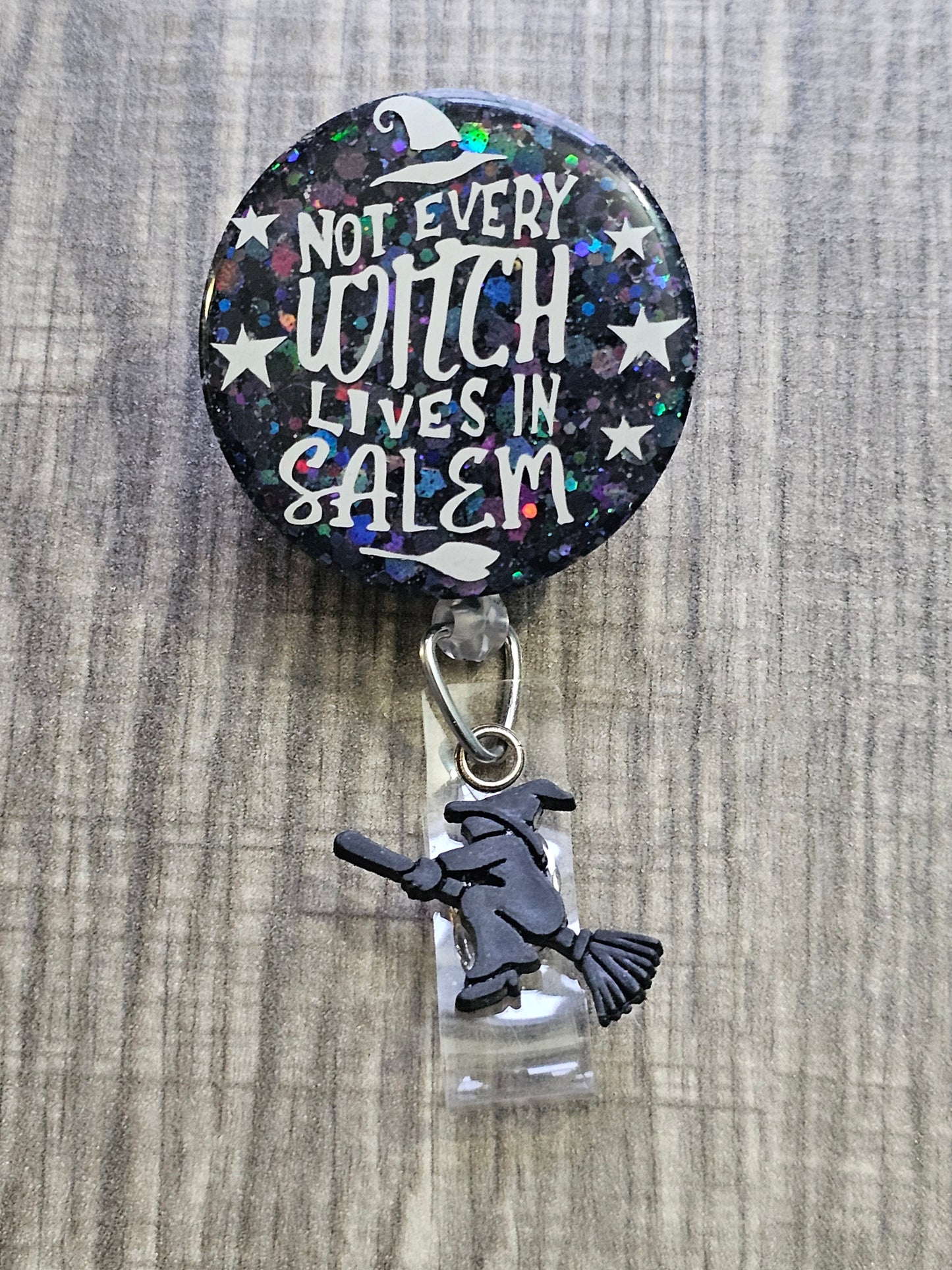  A Badge Reel with a starry background and a witch flying around with a broom with the statement Witch Please. 