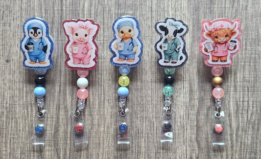 Adorable baby animals (cow, penguin, duck, piglet) wearing green and blue medical scrubs and holding coffee cups on badge reels.