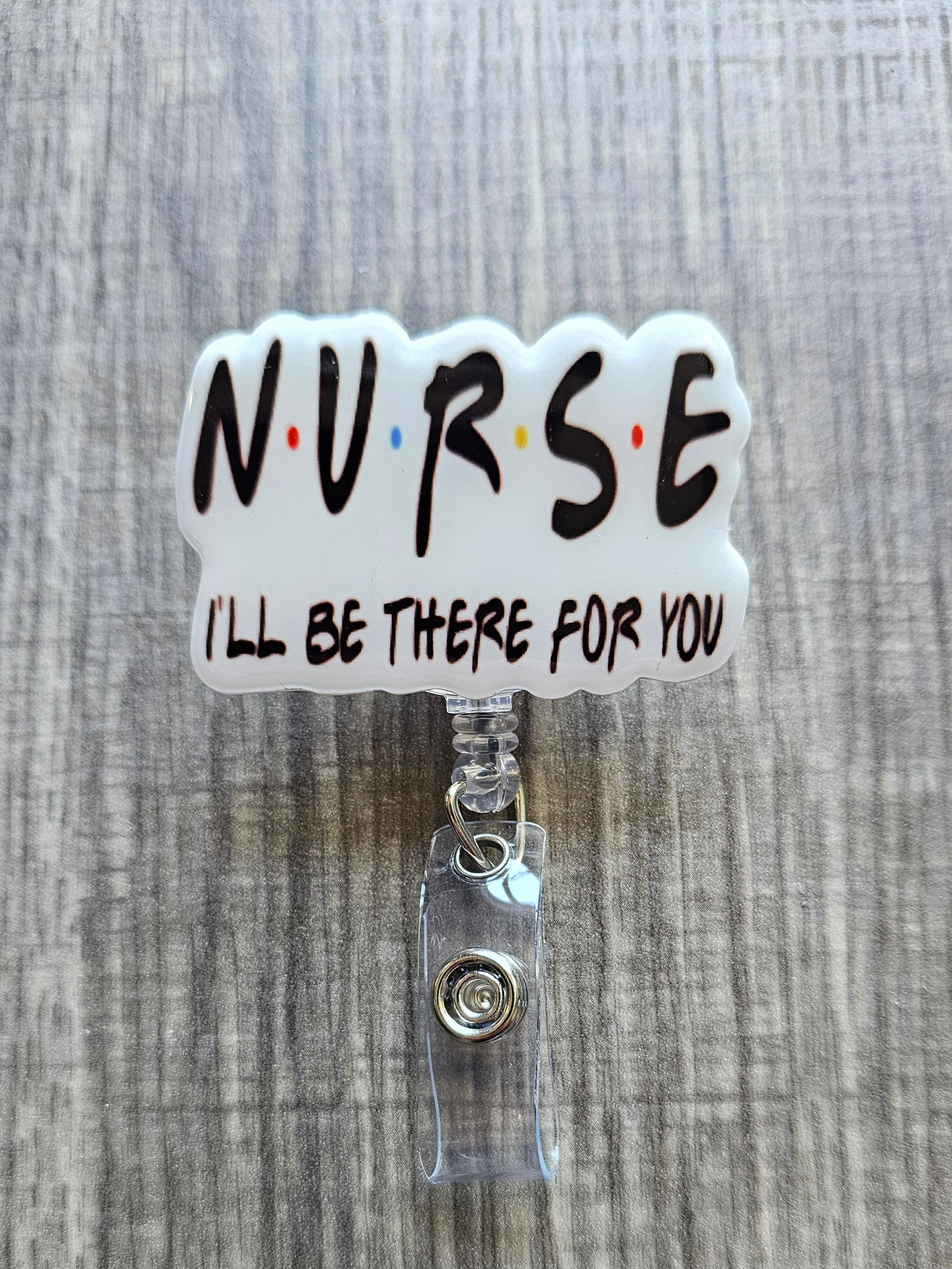 Nurse-themed badge holder with 'NURSE I'll be there for you' text on a textured gray background