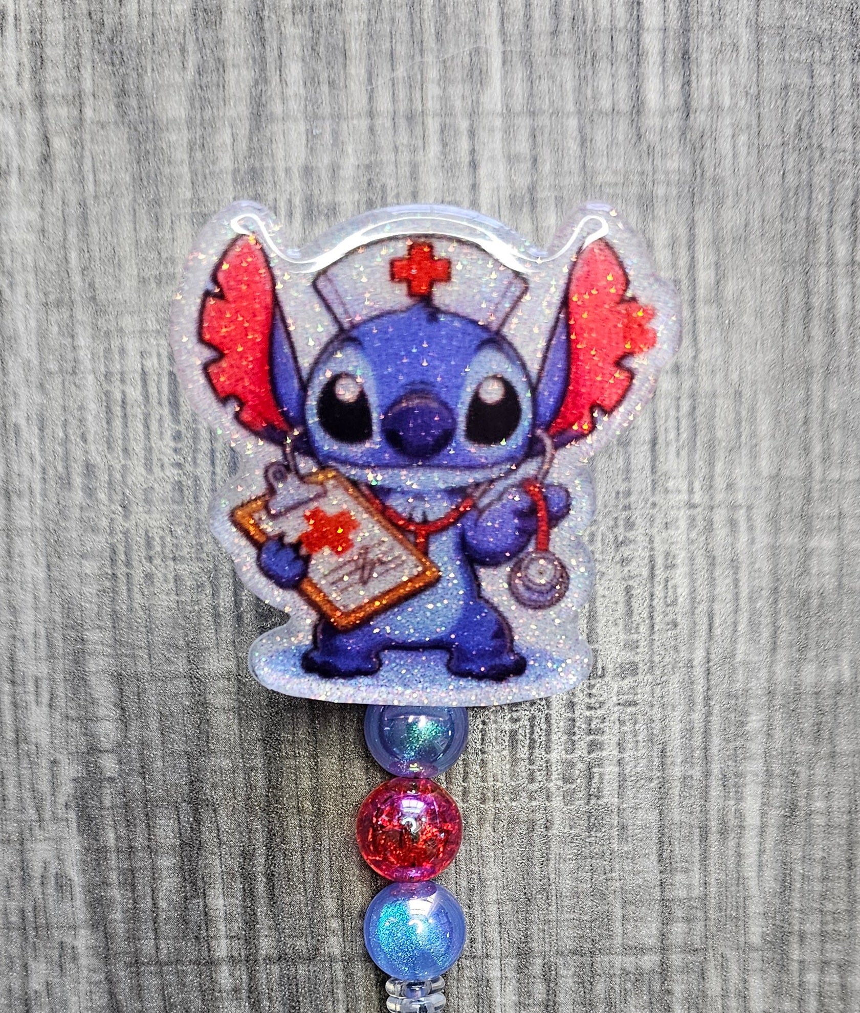 Character resembling Stitch from Lilo & Stitch wearing a nurse's outfit with colorful beads on a textured gray background.