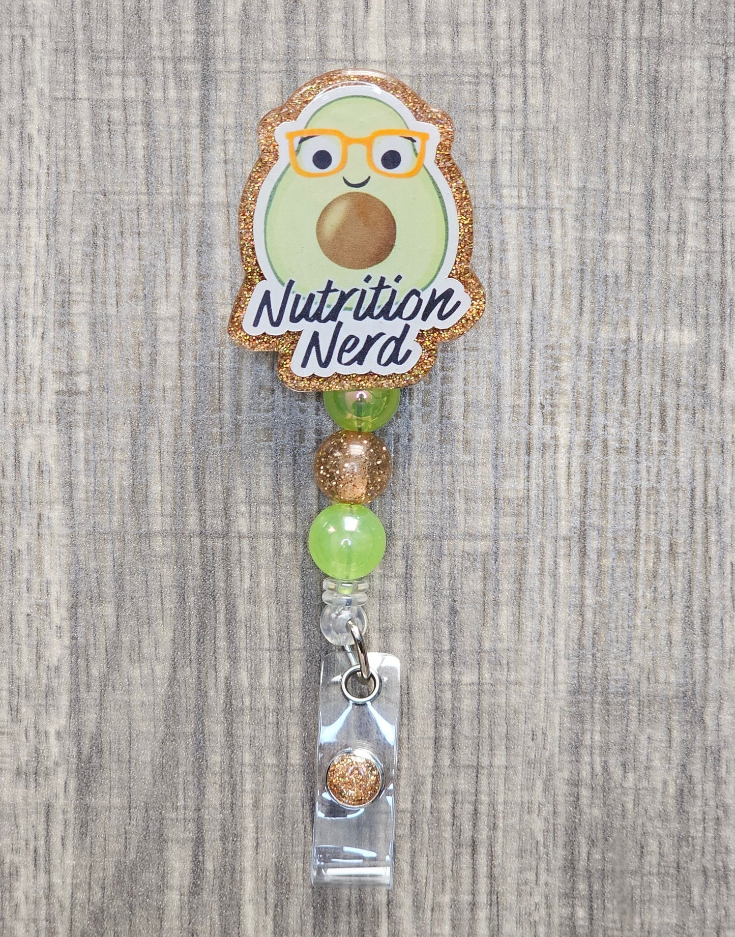 Avocado-themed badge holder with 'Nutrition Nerd' text on a textured background.