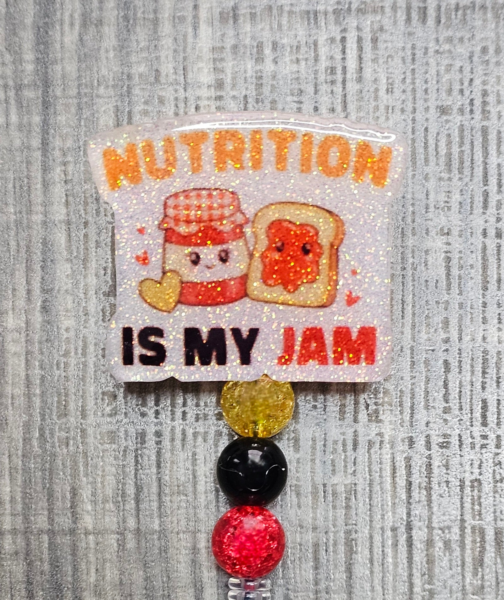 Badge reel featuring a jar of jam and toast with the words "Nutrition Is My Jam."